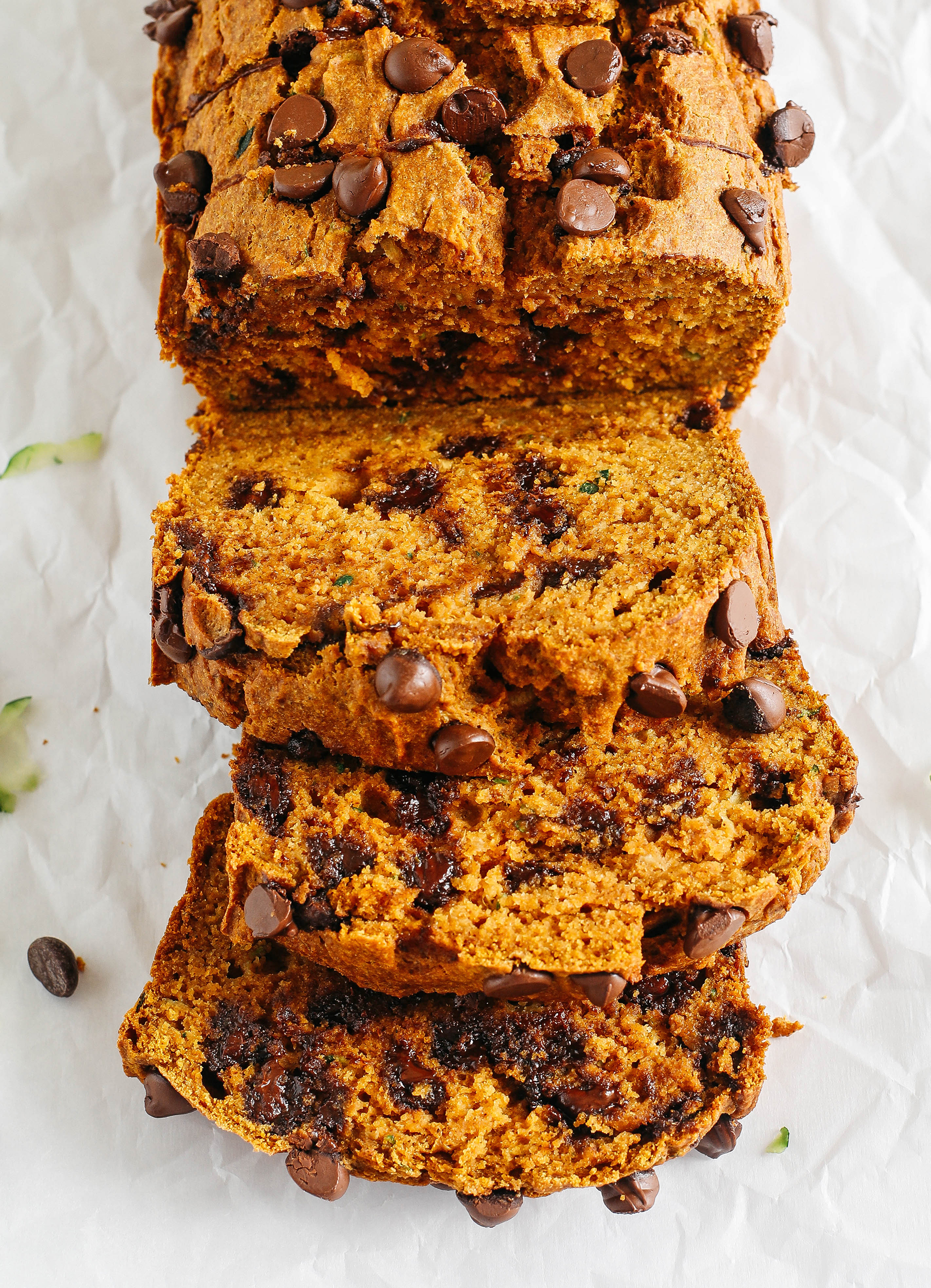 Healthy Pumpkin Zucchini Bread that is moist, fluffy and made healthier with whole wheat flour, Greek yogurt, shredded zucchini and zero butter or refined sugar.  Loaded with warm flavors and studded with chunks of chocolate in every bite!