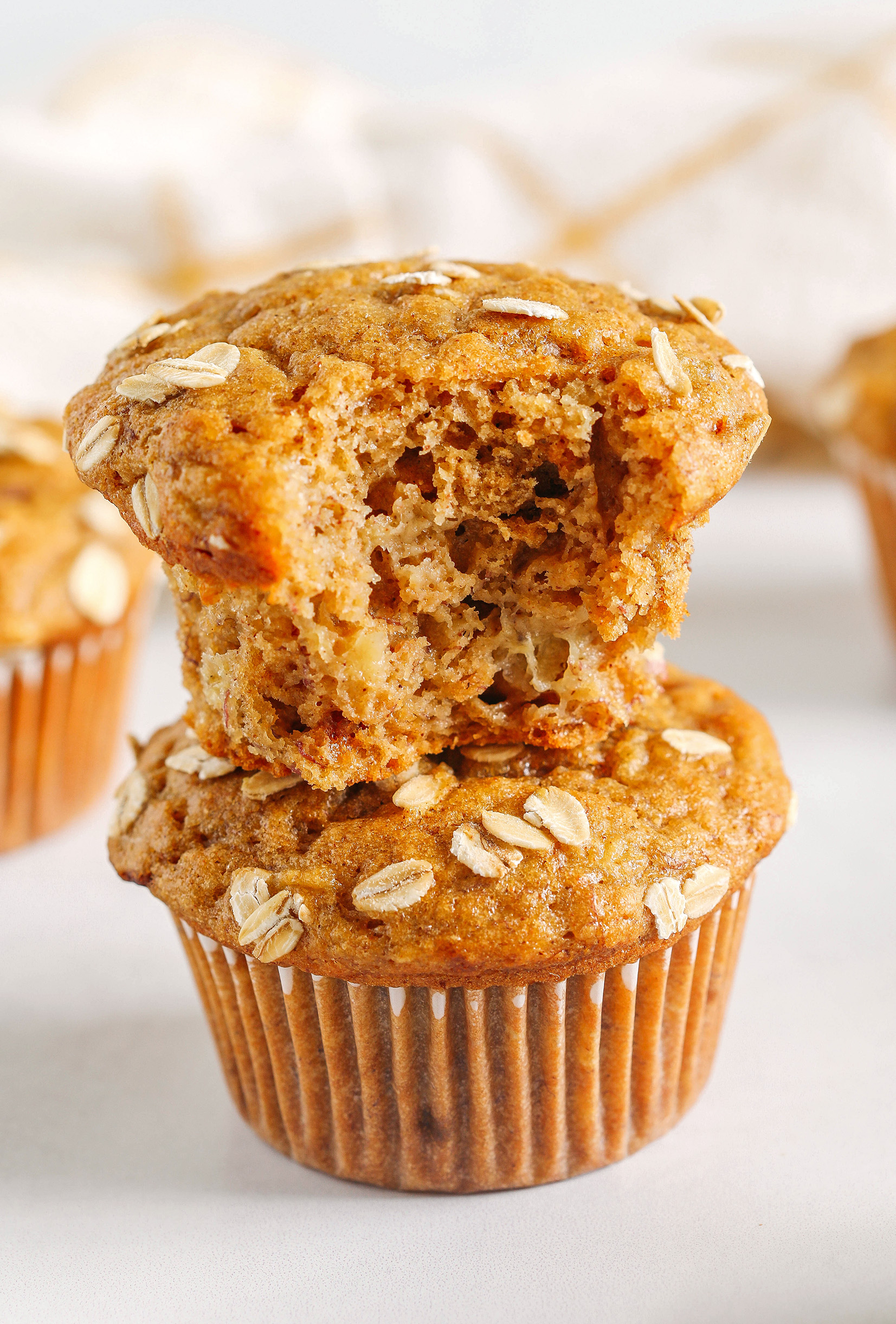 These Banana Breakfast Muffins are moist, fluffy, and made healthier with whole wheat flour, Greek yogurt, and zero butter or refined sugar.  Loaded with delicious banana flavor and warm spices for the perfect morning muffin!