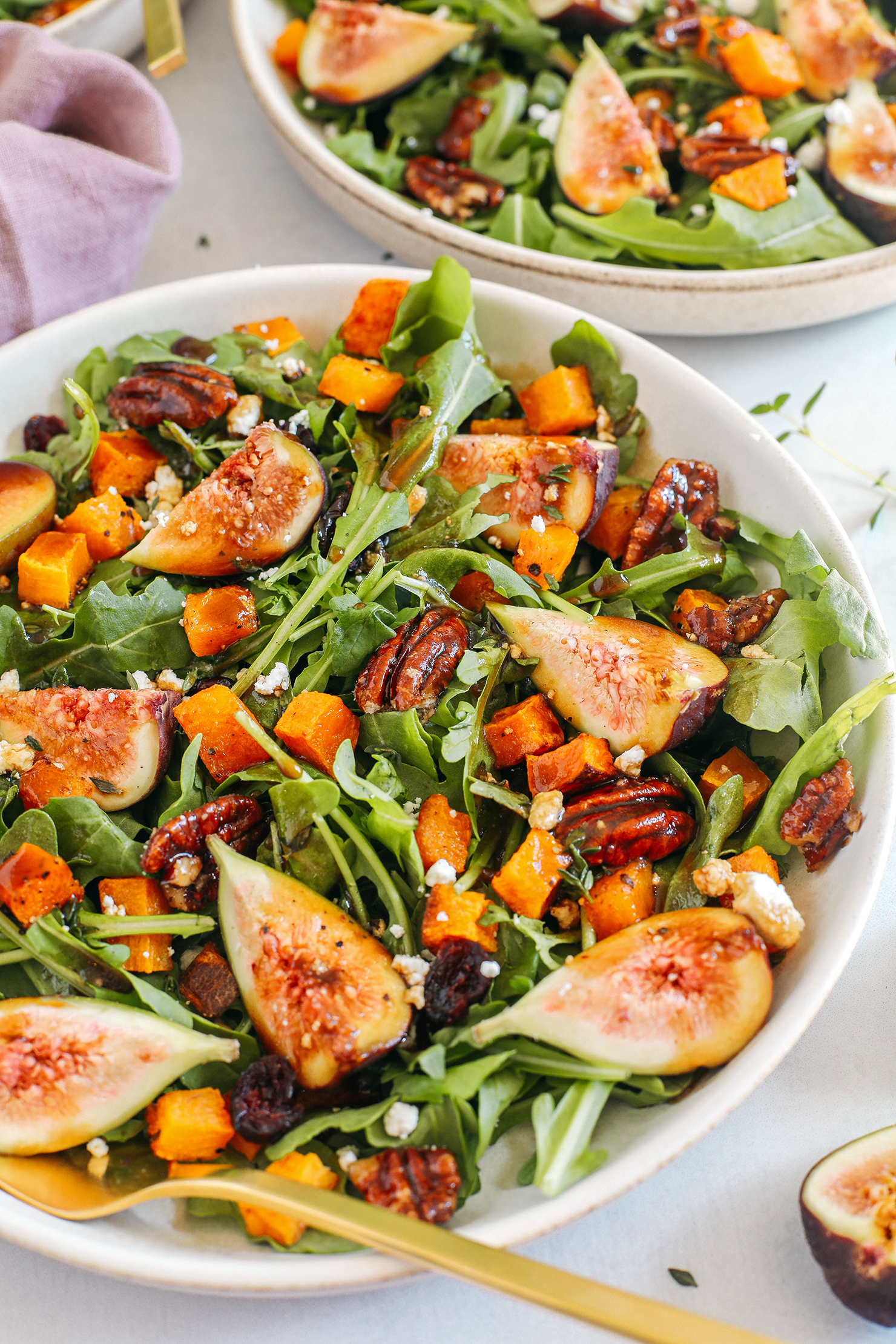 This Fig Salad with Roasted Butternut Squash is the perfect fall salad loaded with leafy greens, fresh figs, candied pecans, and creamy goat cheese all tossed with a rich balsamic dressing!
