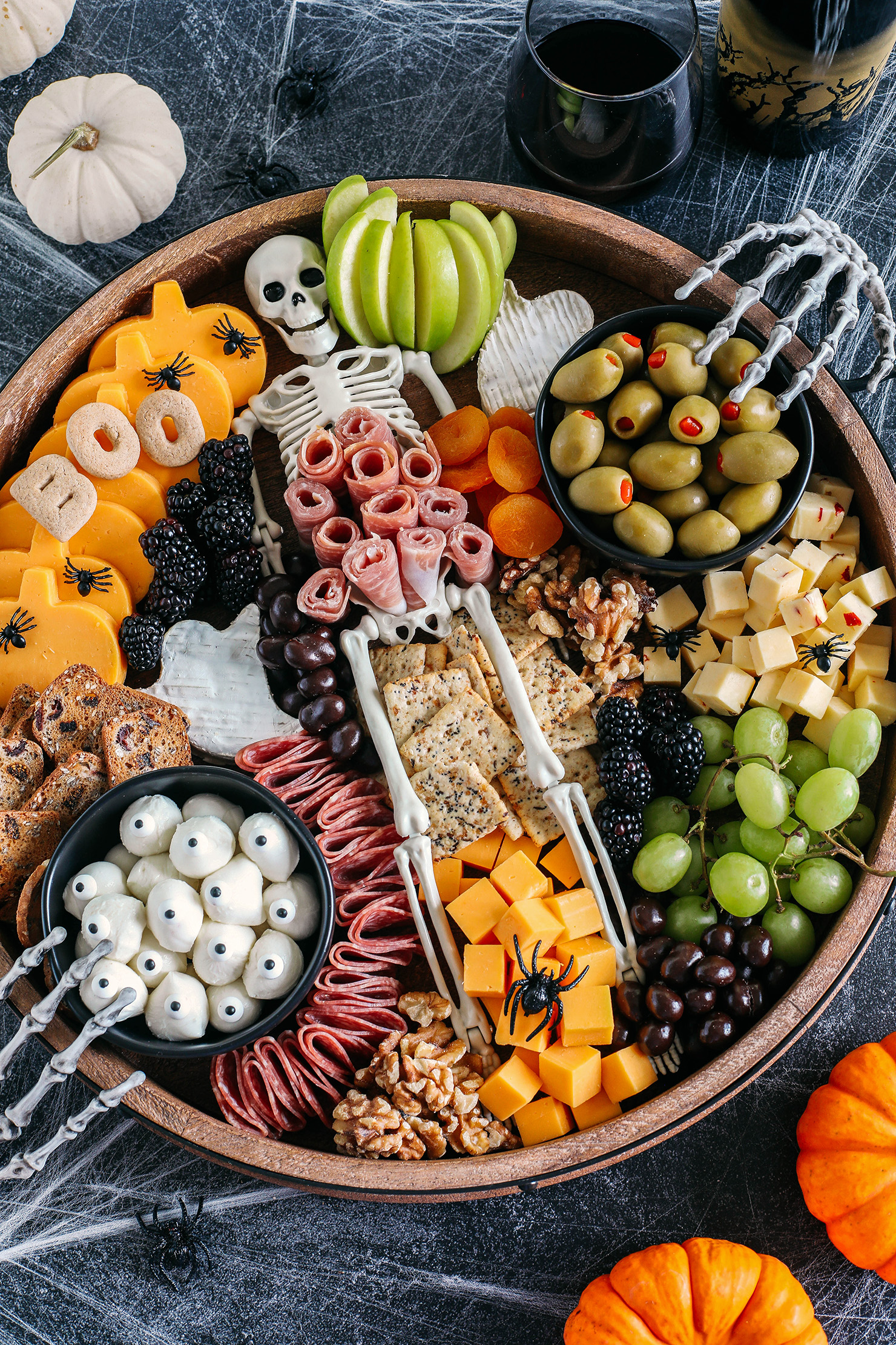 Build the spookiest Halloween Charcuterie Board perfect for your next party!  Filled with an assortment of your favorite cheeses, meats, crackers, fresh fruits, nuts and other fun ghoulish treats!