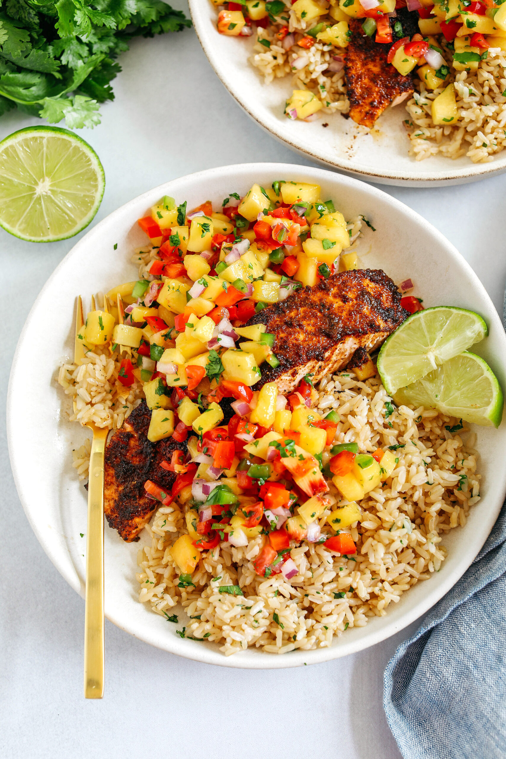 This tender flaky Chili Lime Salmon is coated in a delicious combination of spices and fresh lime juice for a mouthful of flavor!  Pair it with fresh mango salsa and brown rice for the perfect healthy dinner!