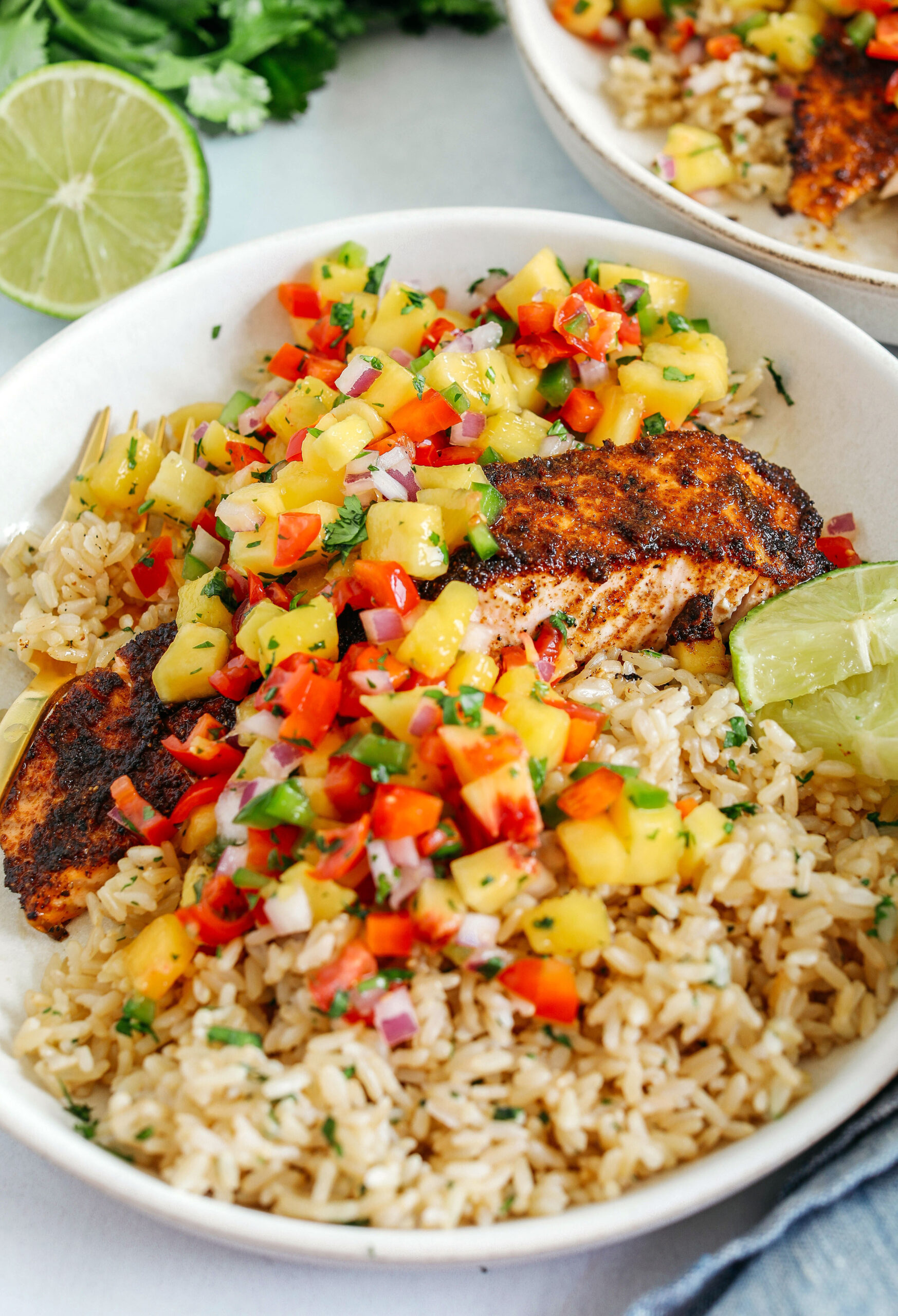 This tender flaky Chili Lime Salmon is coated in a delicious combination of spices and fresh lime juice for a mouthful of flavor!  Pair it with fresh mango salsa and brown rice for the perfect healthy dinner!