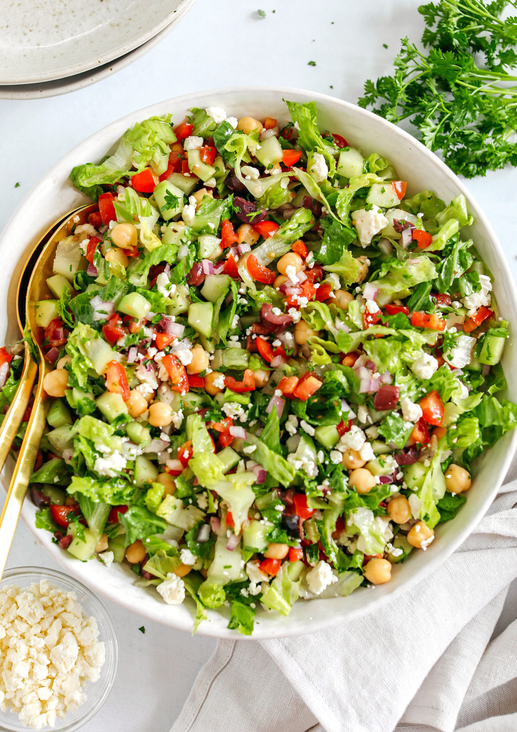 Fresh and crisp Mediterranean Chopped Salad made with fresh tomatoes, crisp cucumbers, red onion, chickpeas, olives and feta cheese all tossed with a delicious red wine vinaigrette!