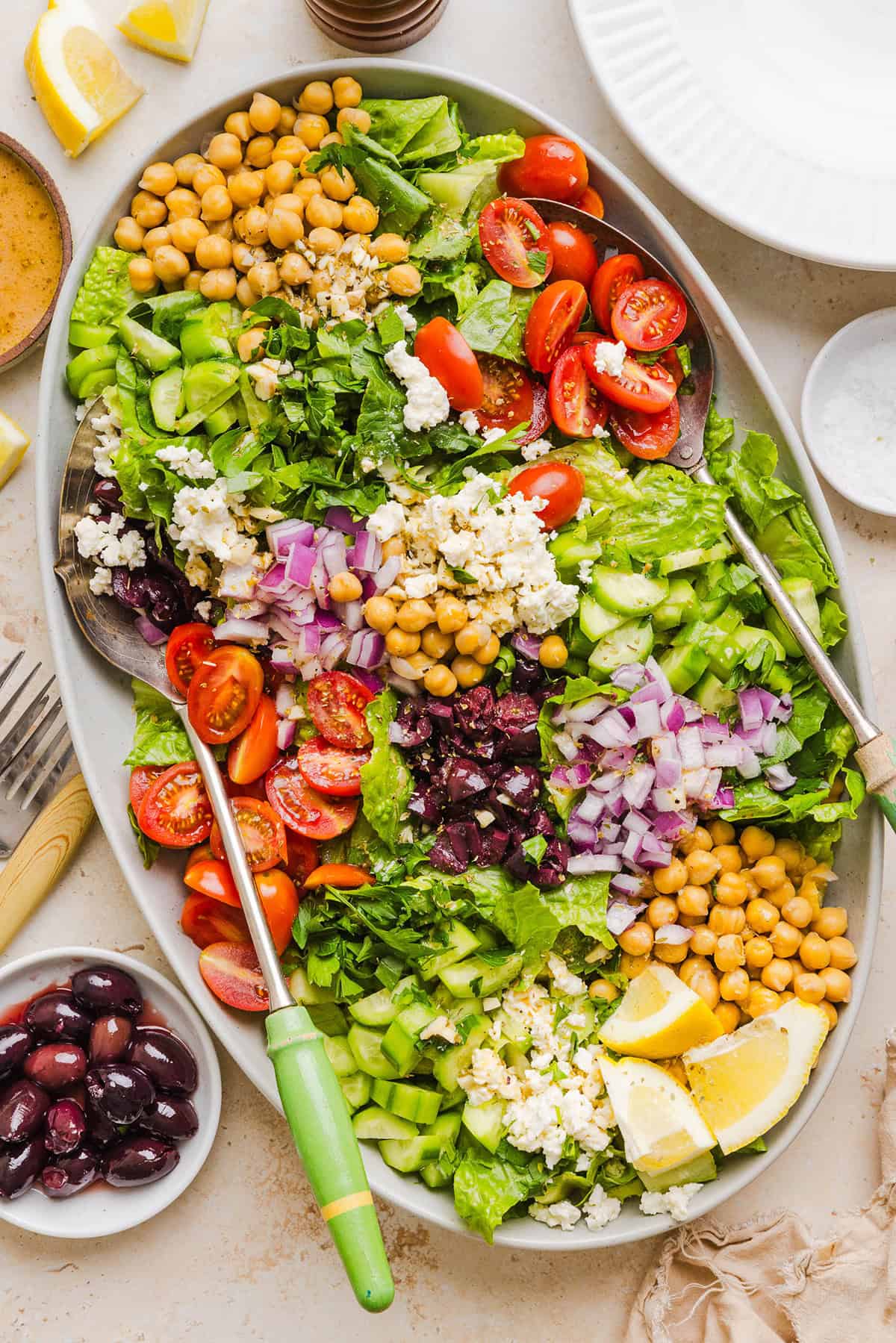 Fresh and crisp Mediterranean Chopped Salad made with fresh tomatoes, crisp cucumbers, red onion, chickpeas, olives and feta cheese all tossed with a delicious red wine vinaigrette! Perfect for meal prep, lunches, or an easy side dish for any meal.