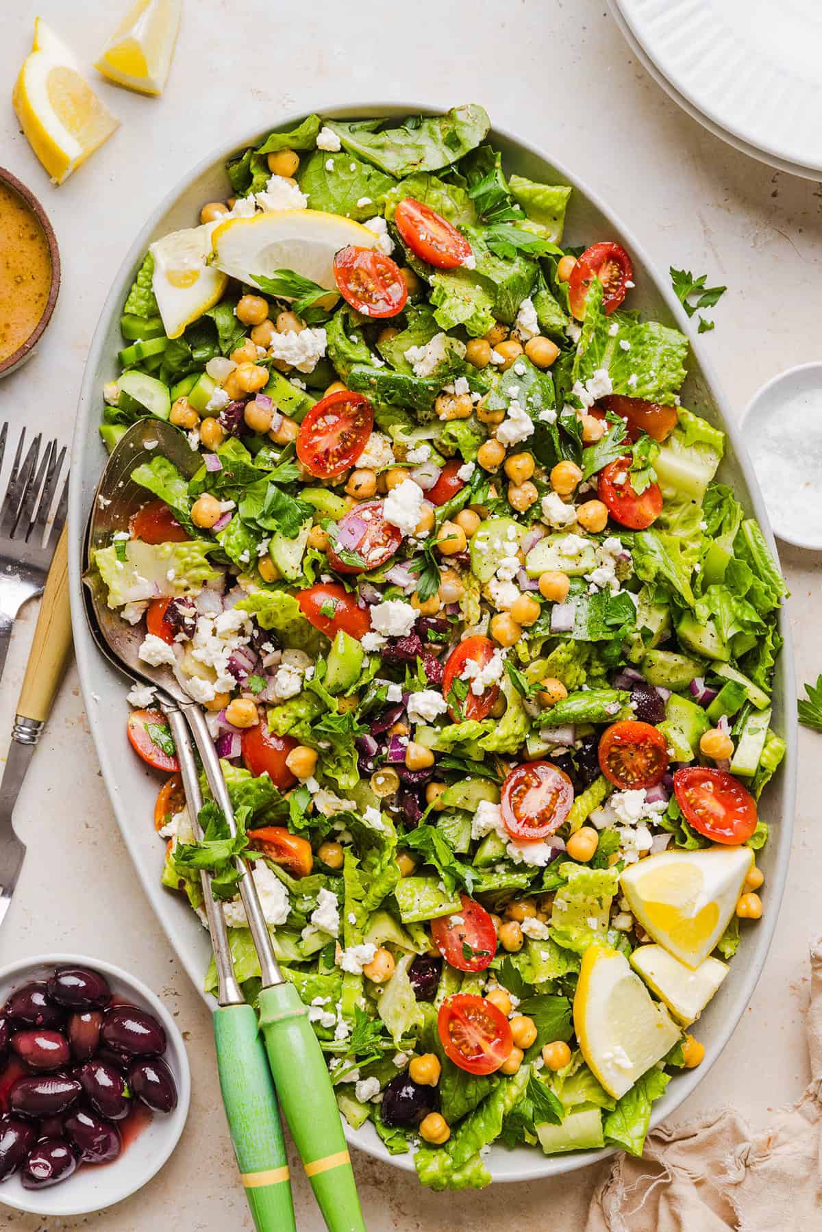 Fresh and crisp Mediterranean Chopped Salad made with fresh tomatoes, crisp cucumbers, red onion, chickpeas, olives and feta cheese all tossed with a delicious red wine vinaigrette! Perfect for meal prep, lunches, or an easy side dish for any meal.