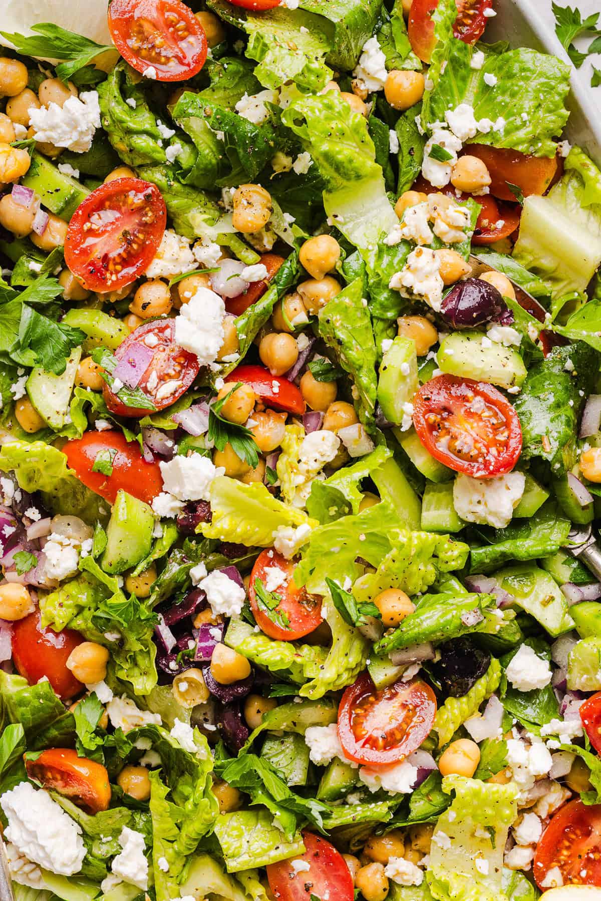Fresh and crisp Mediterranean Chopped Salad made with fresh tomatoes, crisp cucumbers, red onion, chickpeas, olives and feta cheese all tossed with a delicious red wine vinaigrette! Perfect for meal prep, lunches, or an easy side dish for any meal.