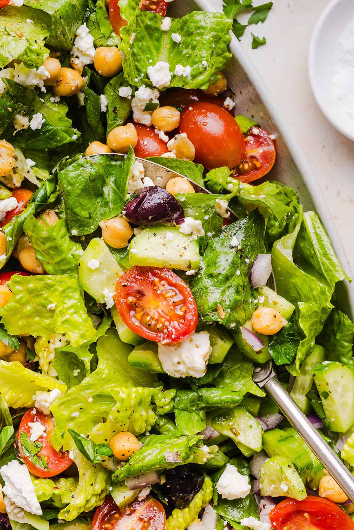 Fresh and crisp Mediterranean Chopped Salad made with fresh tomatoes, crisp cucumbers, red onion, chickpeas, olives and feta cheese all tossed with a delicious red wine vinaigrette! Perfect for meal prep, lunches, or an easy side dish for any meal.