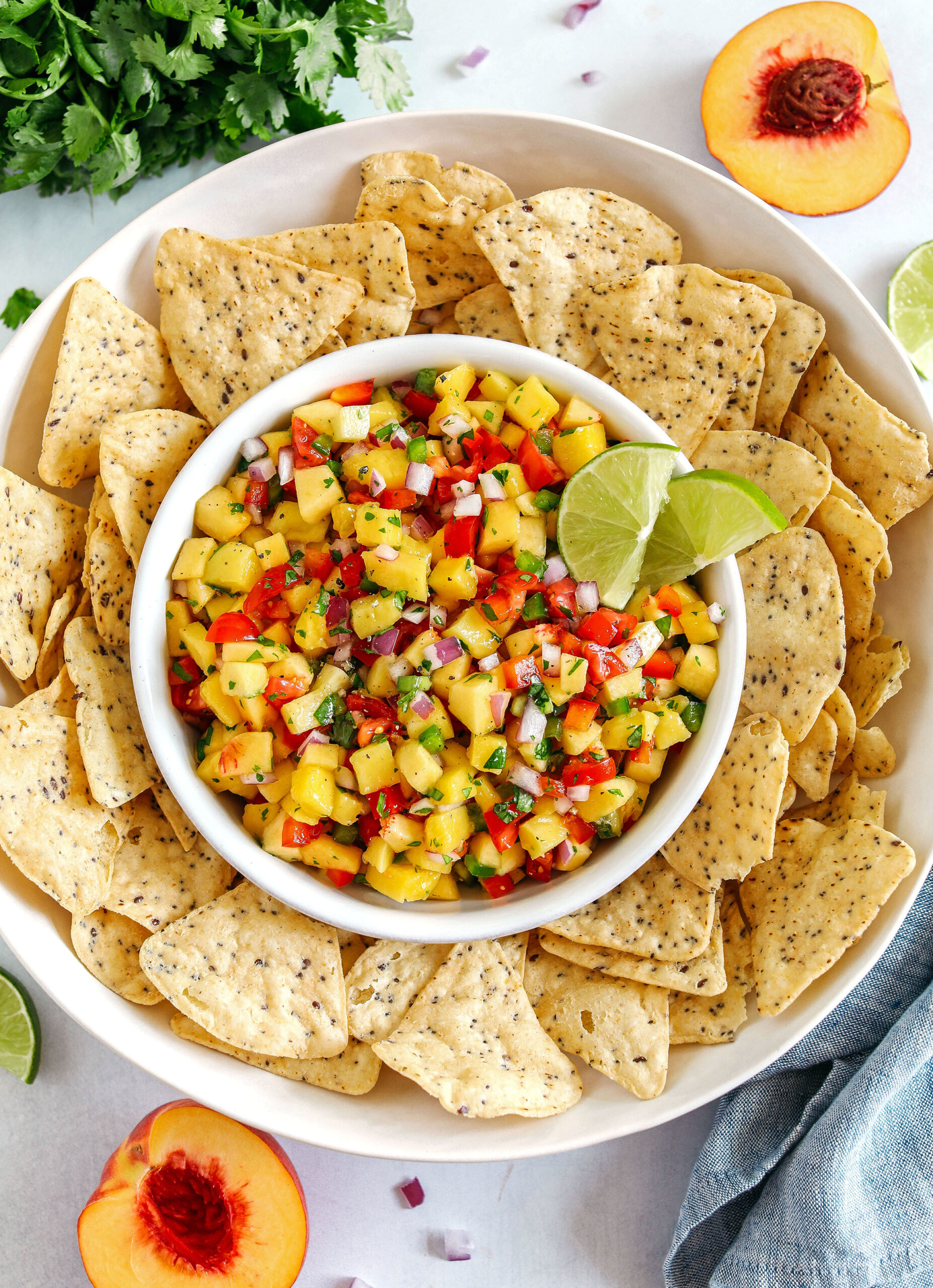 Fresh Peach Mango Salsa easily made in just minutes with only few simple ingredients that makes the perfect topping for tacos, grilled chicken or fish and makes a delicious appetizer served with tortilla chips!