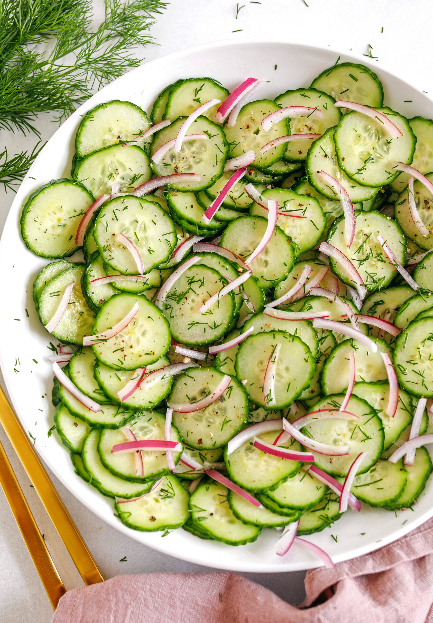 This Sweet Cucumber Salad is made with crisp cucumbers, slices of red onion and fresh dill all tossed in a sweet and tangy vinaigrette that easily comes together in less than 10 minutes!  Perfect summer side dish that is light and refreshing!