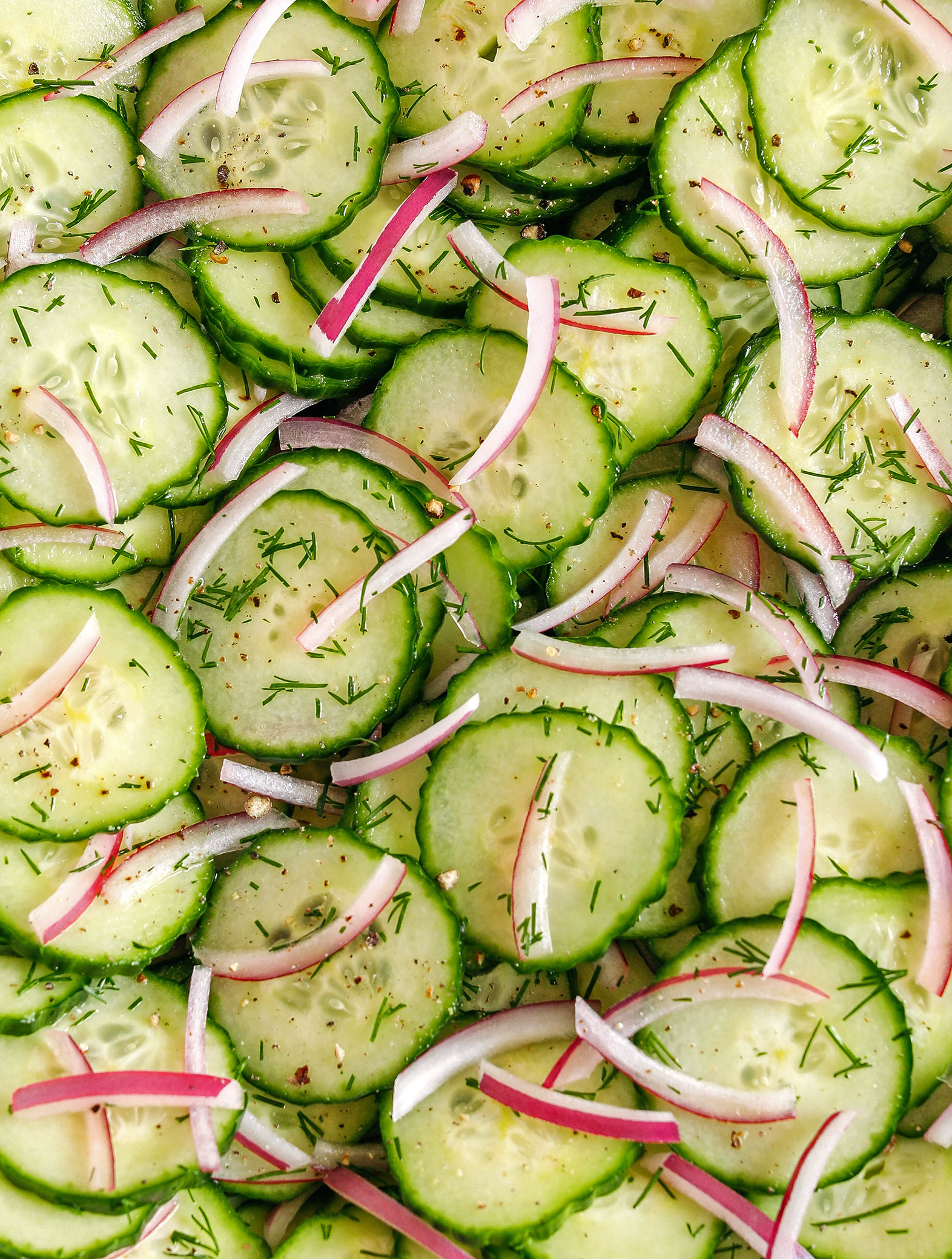 This Sweet Cucumber Salad is made with crisp cucumbers, slices of red onion and fresh dill all tossed in a sweet and tangy vinaigrette that easily comes together in less than 10 minutes!  Perfect summer side dish that is light and refreshing!