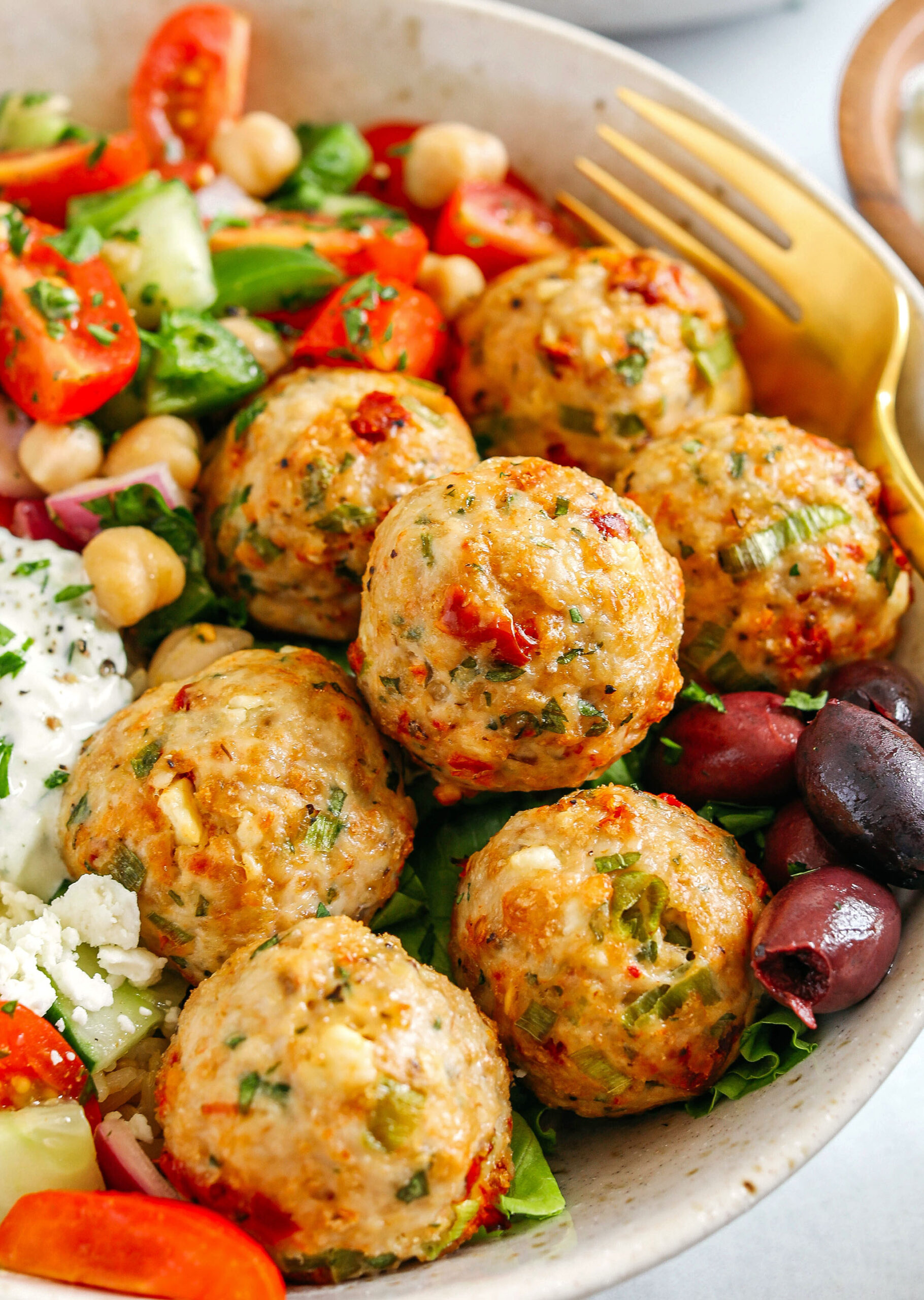 The most delicious Mediterranean Chicken Meatballs packed with flavor and easily made in under 30 minutes!  Serve with brown rice, homemade tzatziki sauce, sprinkle on some feta cheese, or pair with a tomato and chickpea salad for a complete meal!