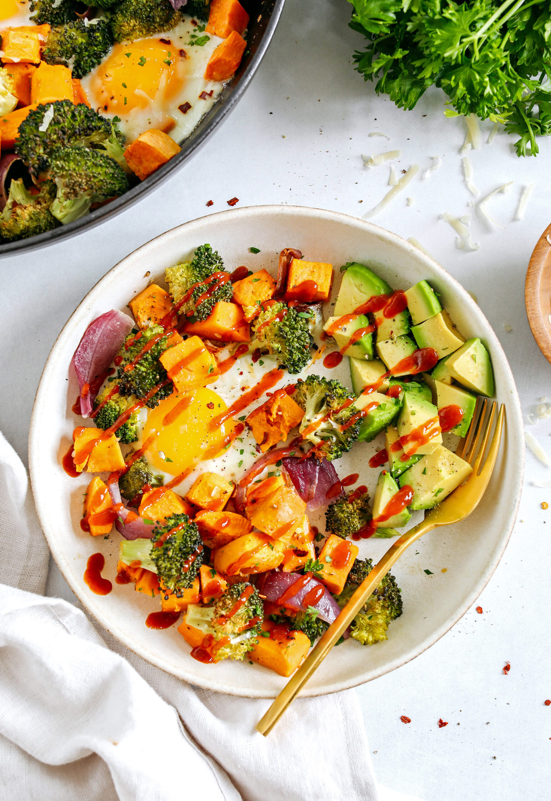 Roasted Veggie Breakfast Skillet made all in one pan with a hearty combination of sweet potatoes, broccoli and red onion topped with baked eggs and seasoned to perfection for a healthy delicious breakfast or dinner!