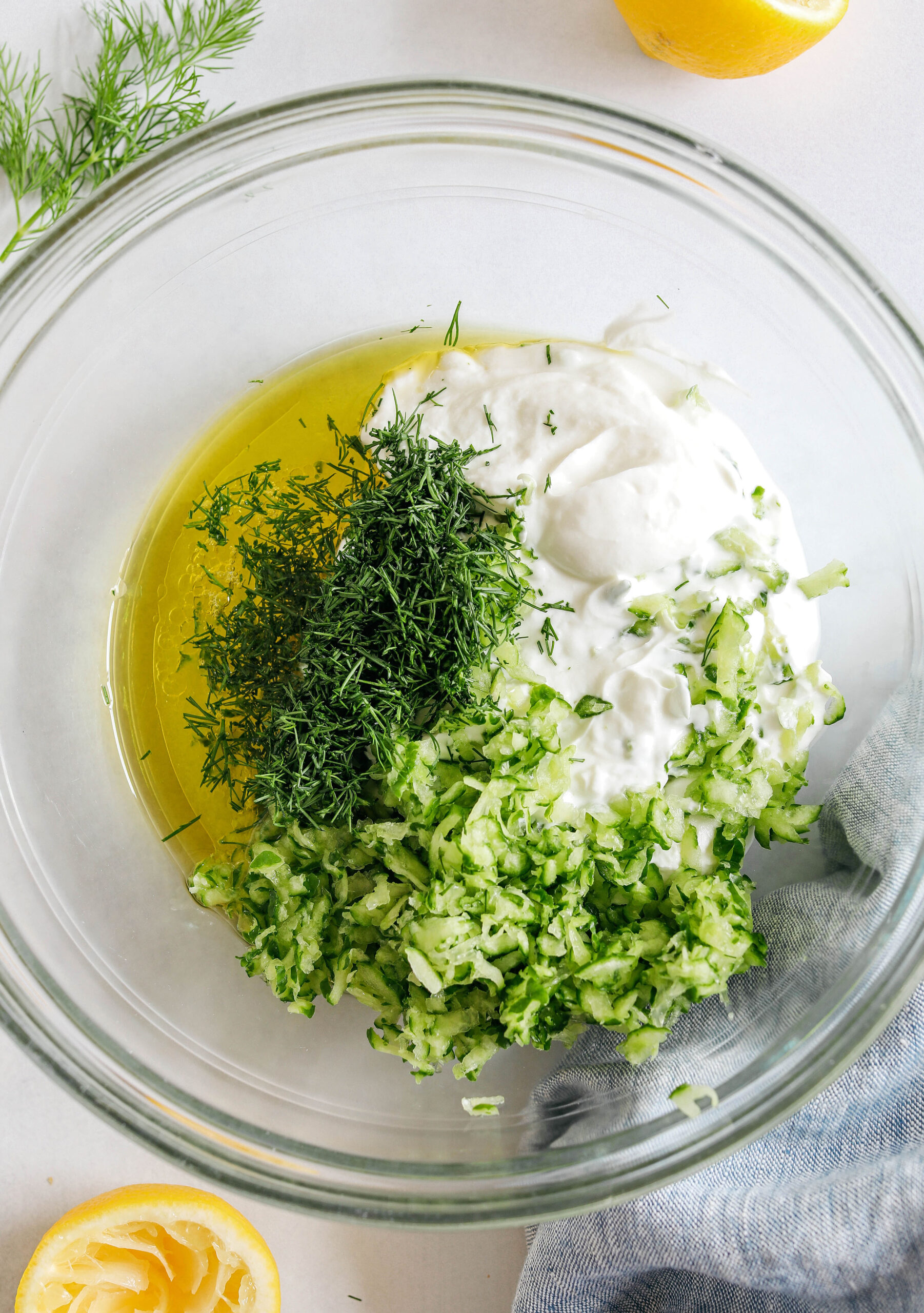Fresh and flavorful Homemade Tzatziki Sauce is a creamy yogurt-based sauce perfect for the summer served with kabobs, grilled veggies, pita bread and more!  This recipe is easily made in just 5 minutes with a few simple ingredients!