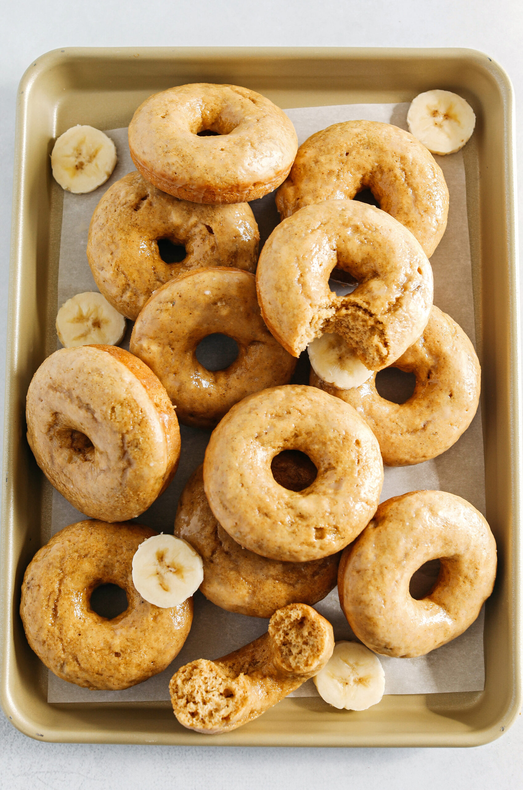 These Baked Banana Bread Donuts are soft, cake-like and made healthier with whole wheat flour, applesauce and zero refined sugar for the perfect morning treat that comes together in just 20 minutes!  Such a great way to use up those overripe bananas!