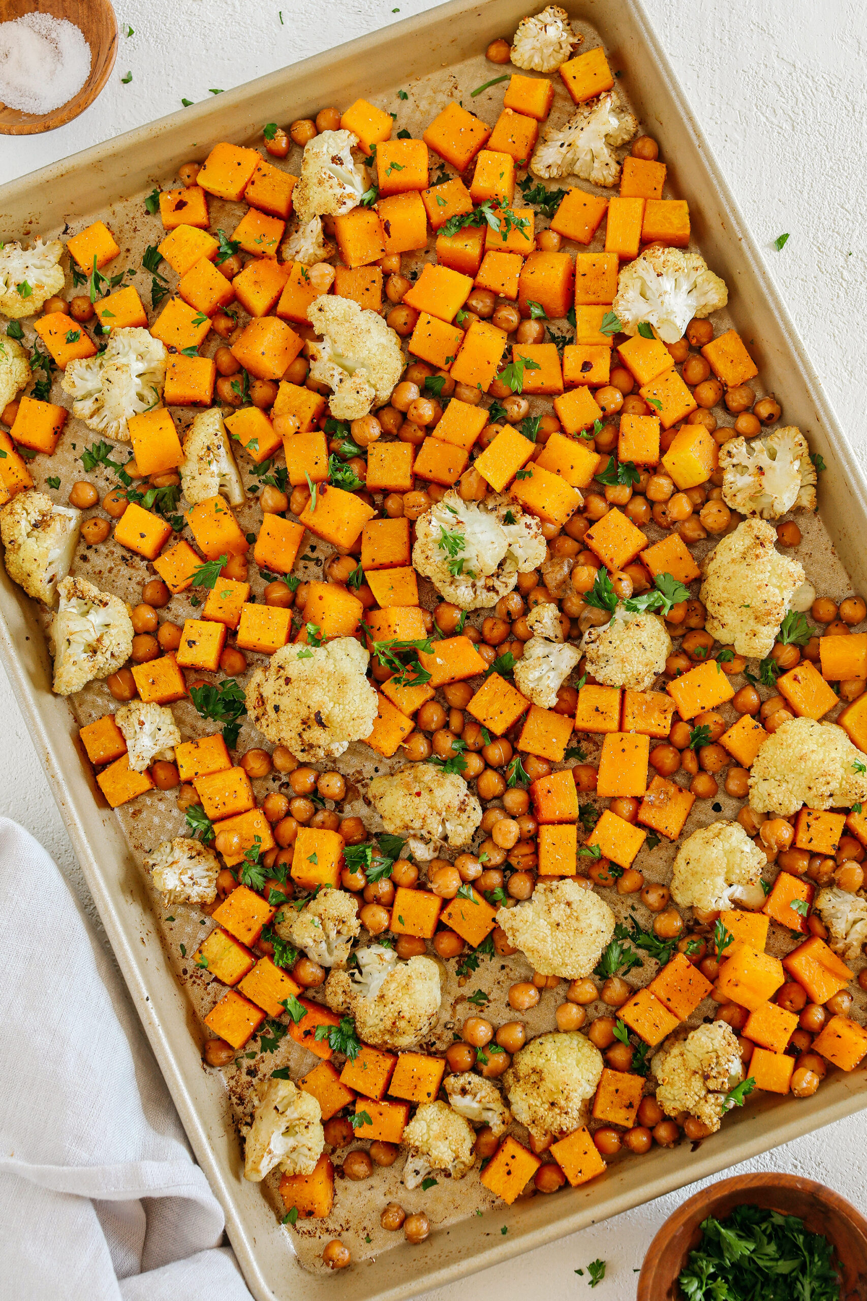 Roasted Squash, Cauliflower and Chickpeas that are perfectly seasoned and cooked all on one sheet pan for an easy and delicious healthy side dish the whole family will love!