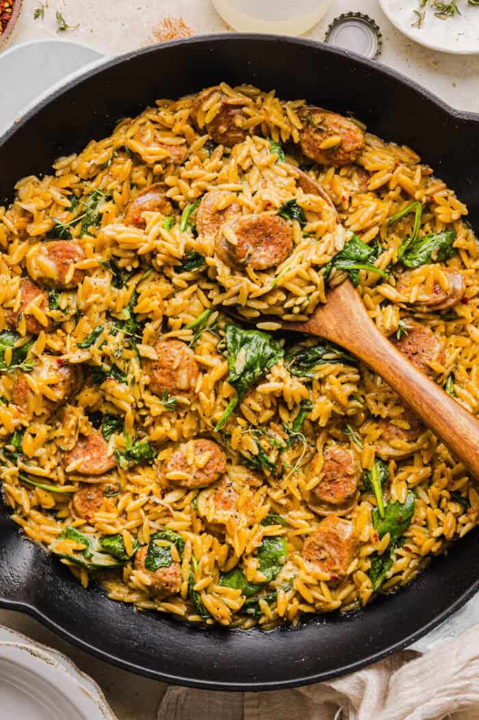 This Creamy Chicken Sausage Orzo Skillet is the perfect weeknight meal loaded with flavorful chicken sausage, tender orzo, tons of garlic and leafy spinach easily made in just 20 minutes all in one pan!  
