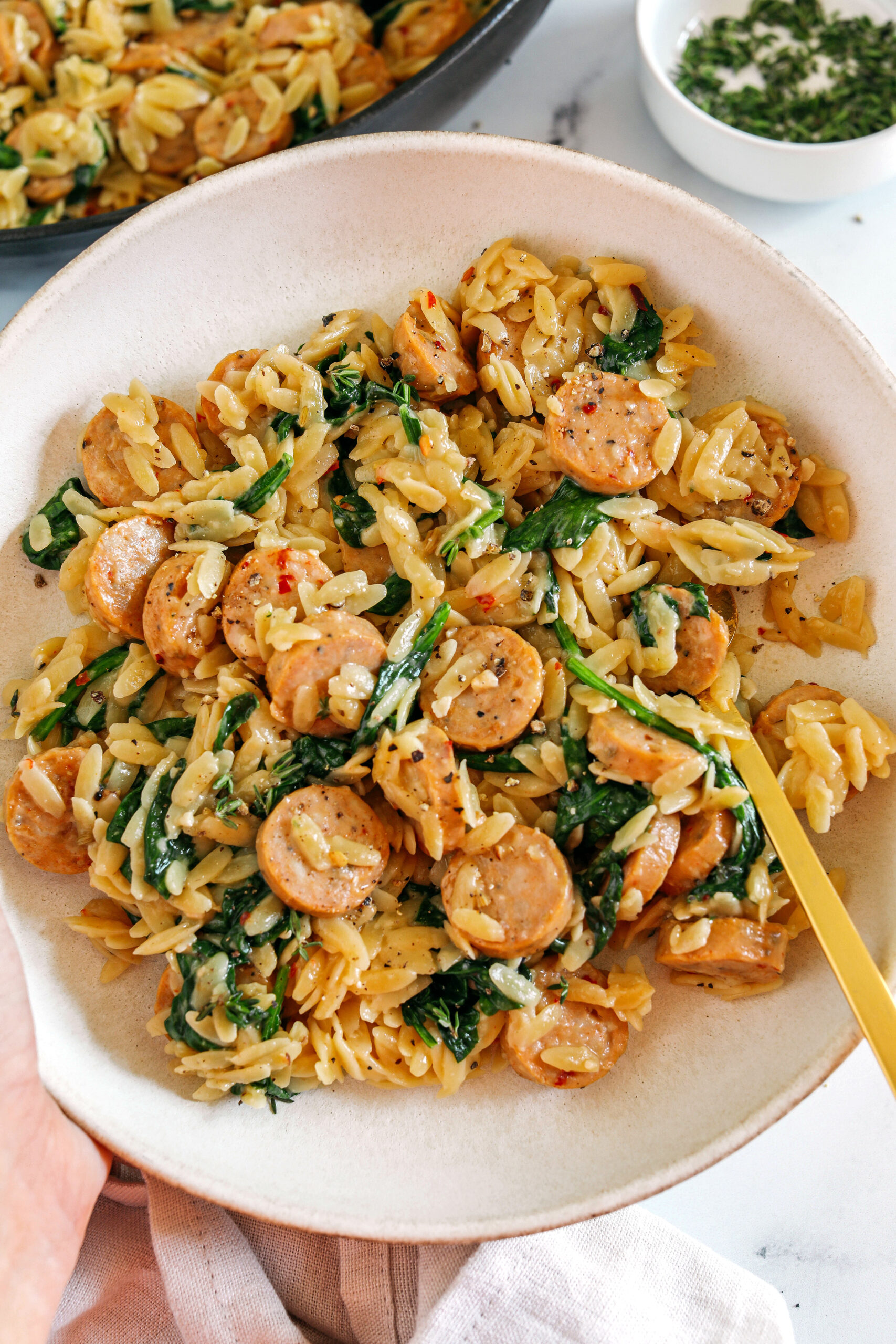 This Creamy Chicken Sausage Orzo Skillet is the perfect weeknight meal loaded with flavorful chicken sausage, tender orzo, tons of garlic and leafy spinach easily made in just 20 minutes all in one pan!  