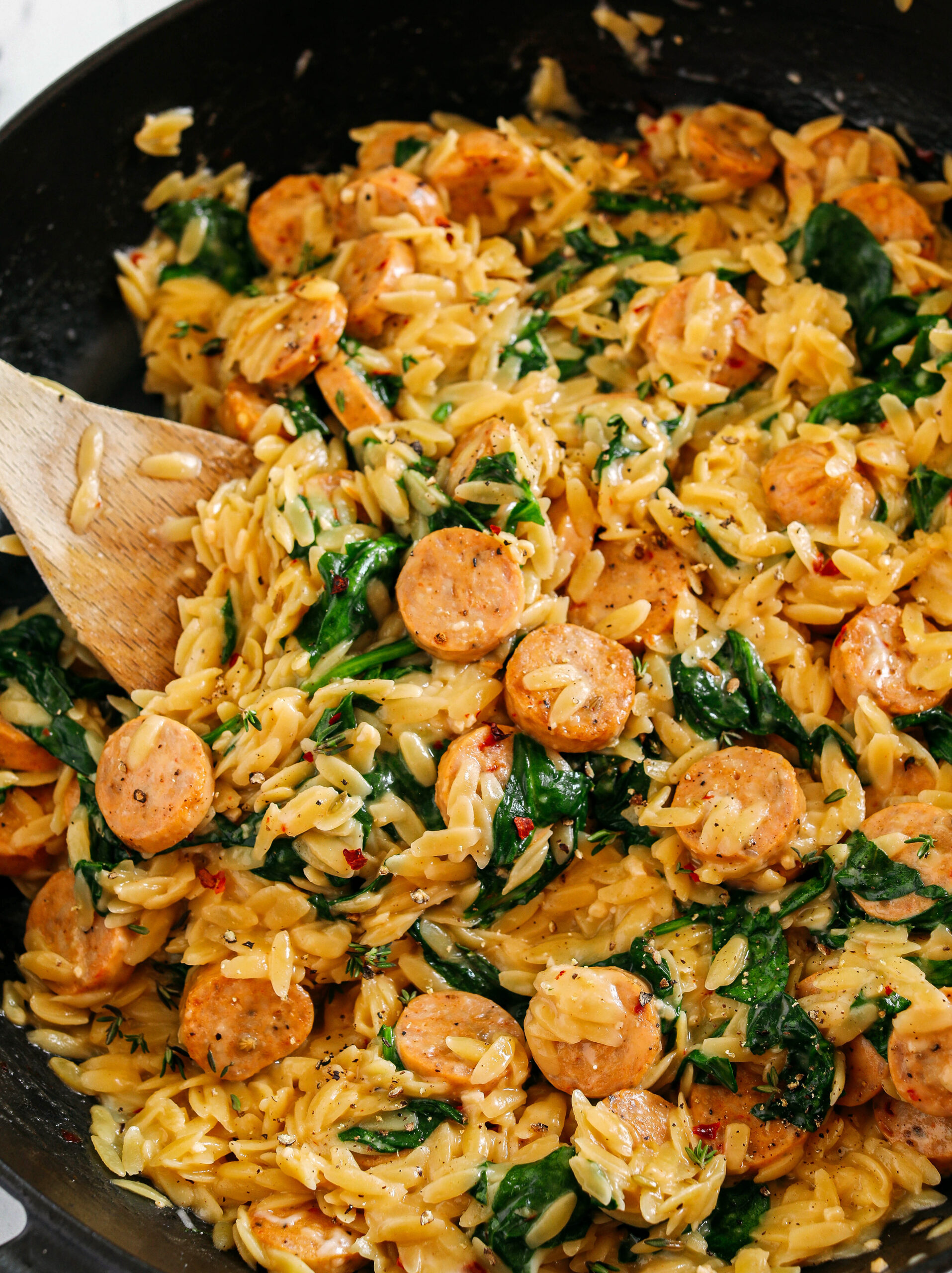 This Creamy Chicken Sausage Orzo Skillet is the perfect weeknight meal loaded with flavorful chicken sausage, tender orzo, tons of garlic and leafy spinach easily made in just 20 minutes all in one pan!  
