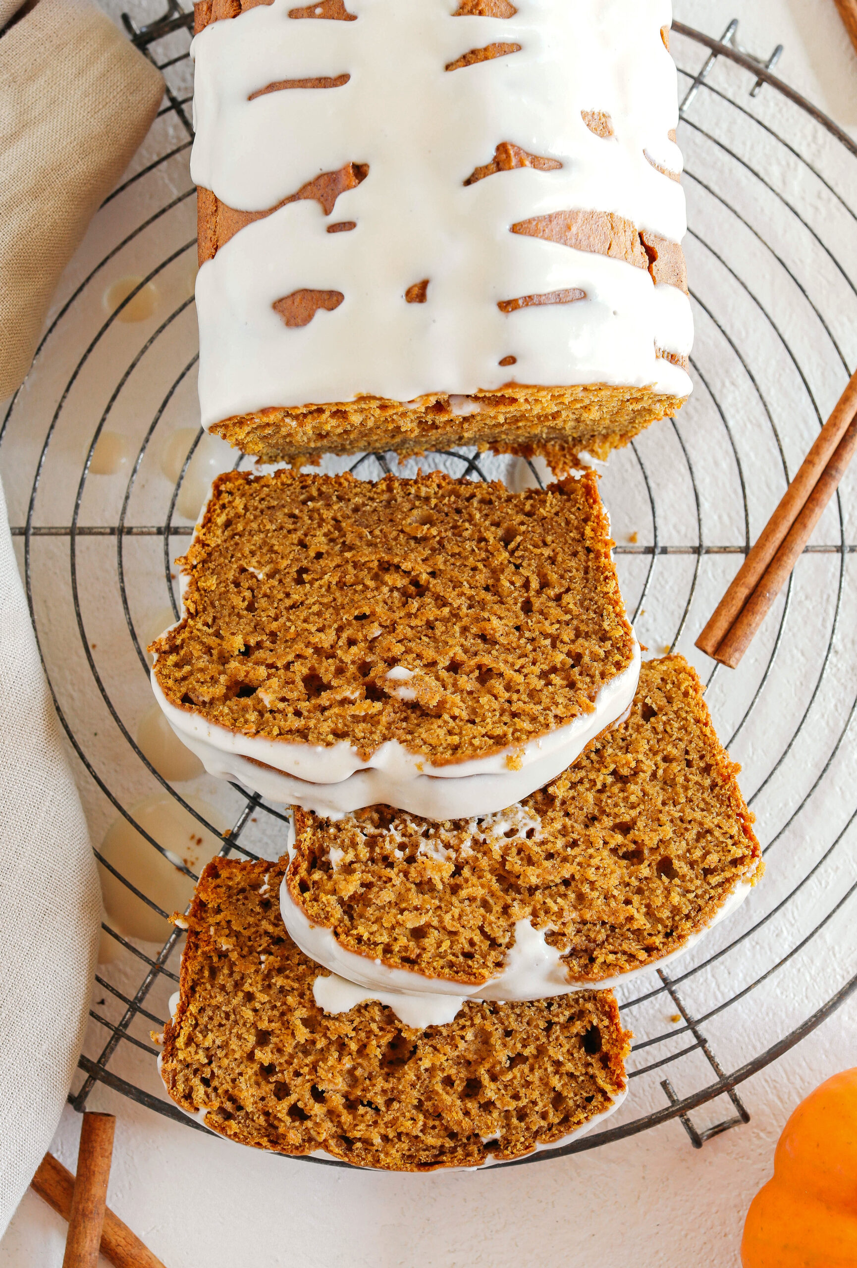 The BEST Healthy Pumpkin Bread recipe that is moist, loaded with pumpkin flavor and made without any butter or refined sugar!  Topped with a delicious maple cream cheese glaze for the perfect fall treat this season!