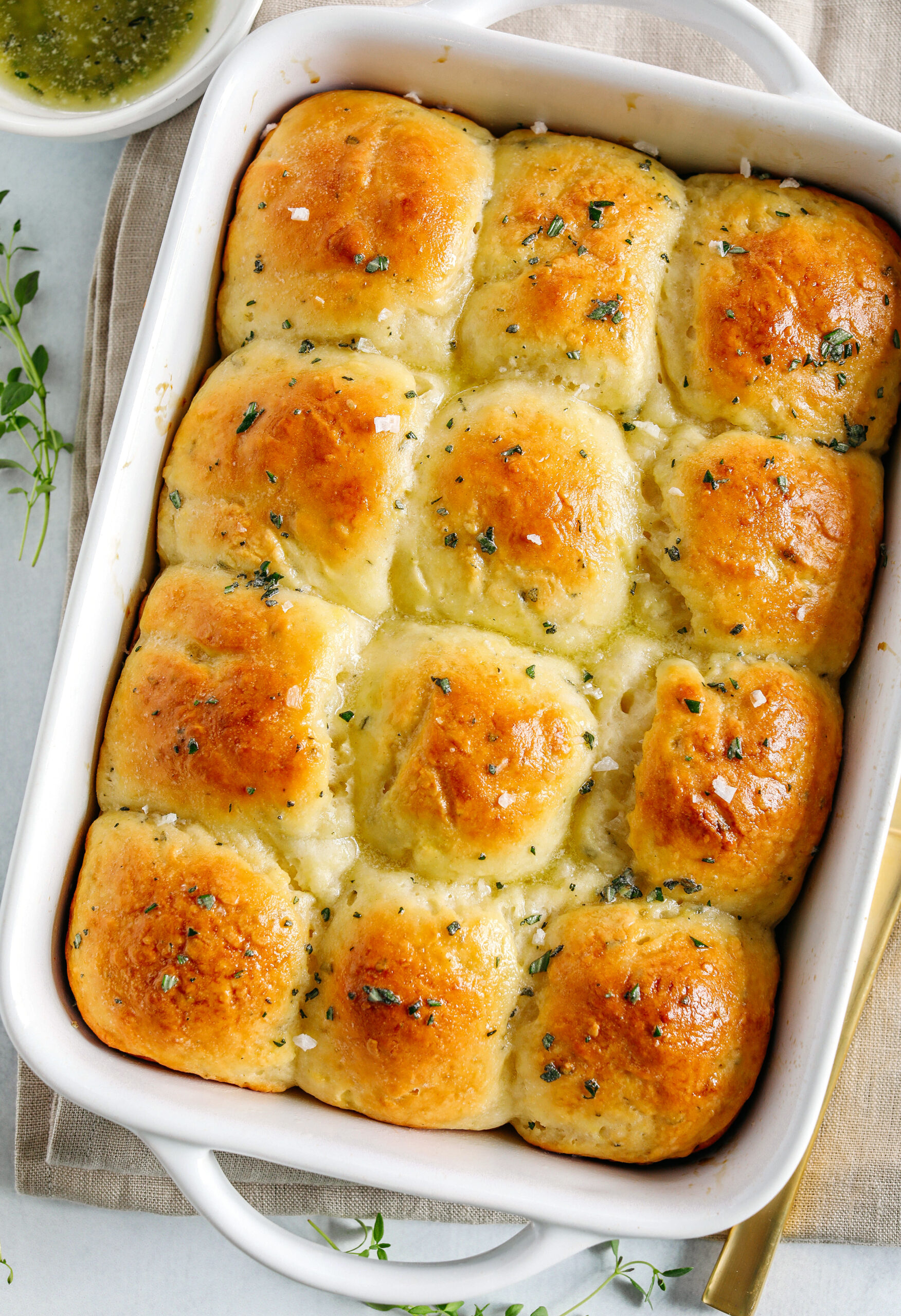 These pull-apart Honey Butter Dinner Rolls are light, fluffy and made without any yeast, eggs or oil.  Infused with honey and fresh herbs, these Parker House-style dinner rolls are perfect for your holiday table this season!