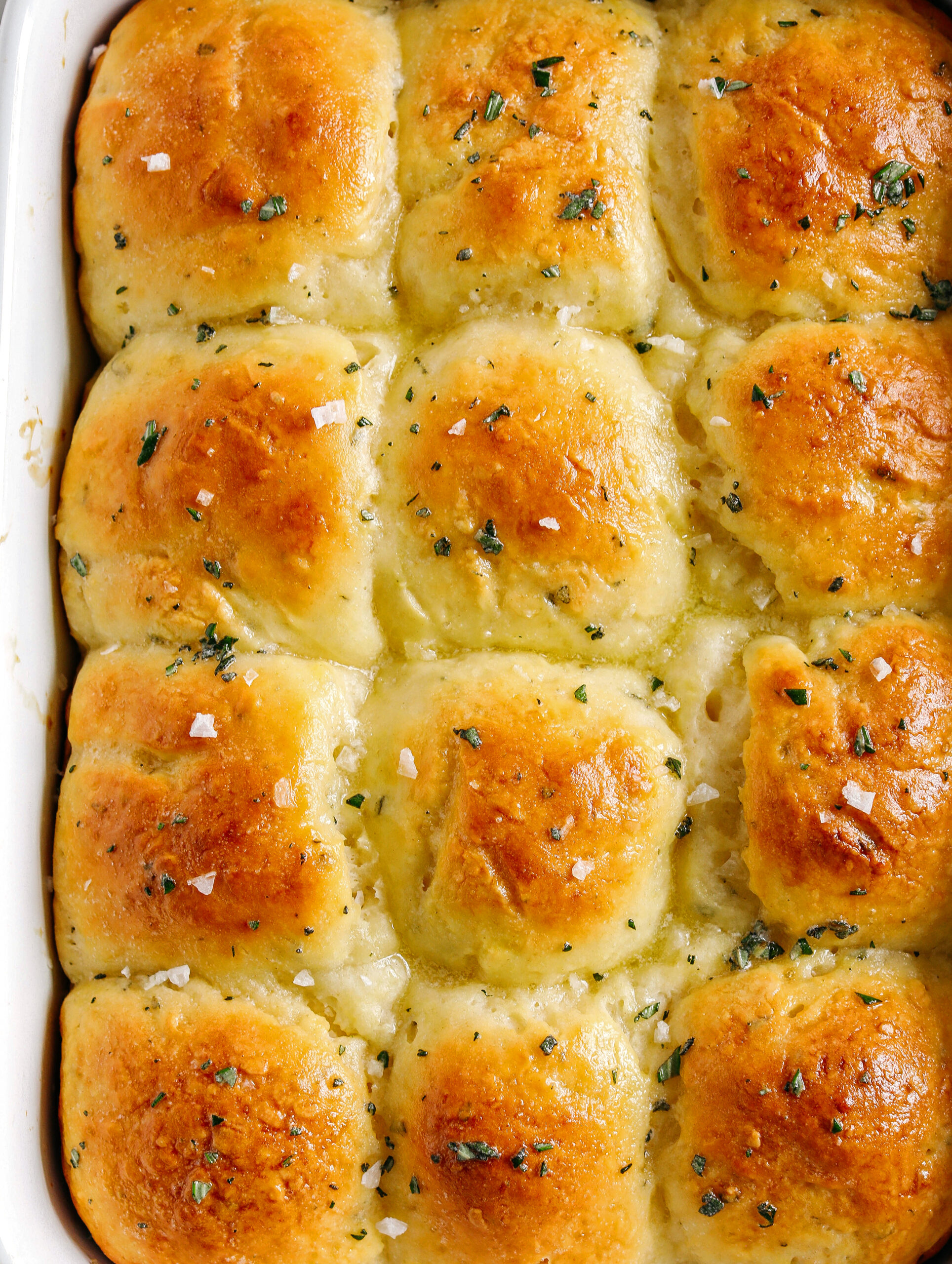 These pull-apart Honey Butter Dinner Rolls are light, fluffy and made without any yeast, eggs or oil.  Infused with honey and fresh herbs, these Parker House-style dinner rolls are perfect for your holiday table this season!