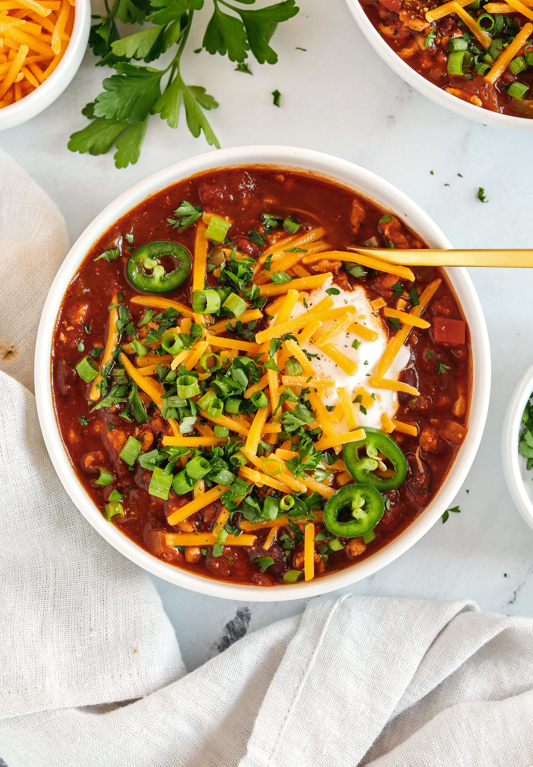 The BEST Healthy Turkey Chili recipe full of fresh veggies, lean ground turkey and loaded with flavor!  The perfect cozy chili you can easily make in our instant pot, crock pot or right on the stove!