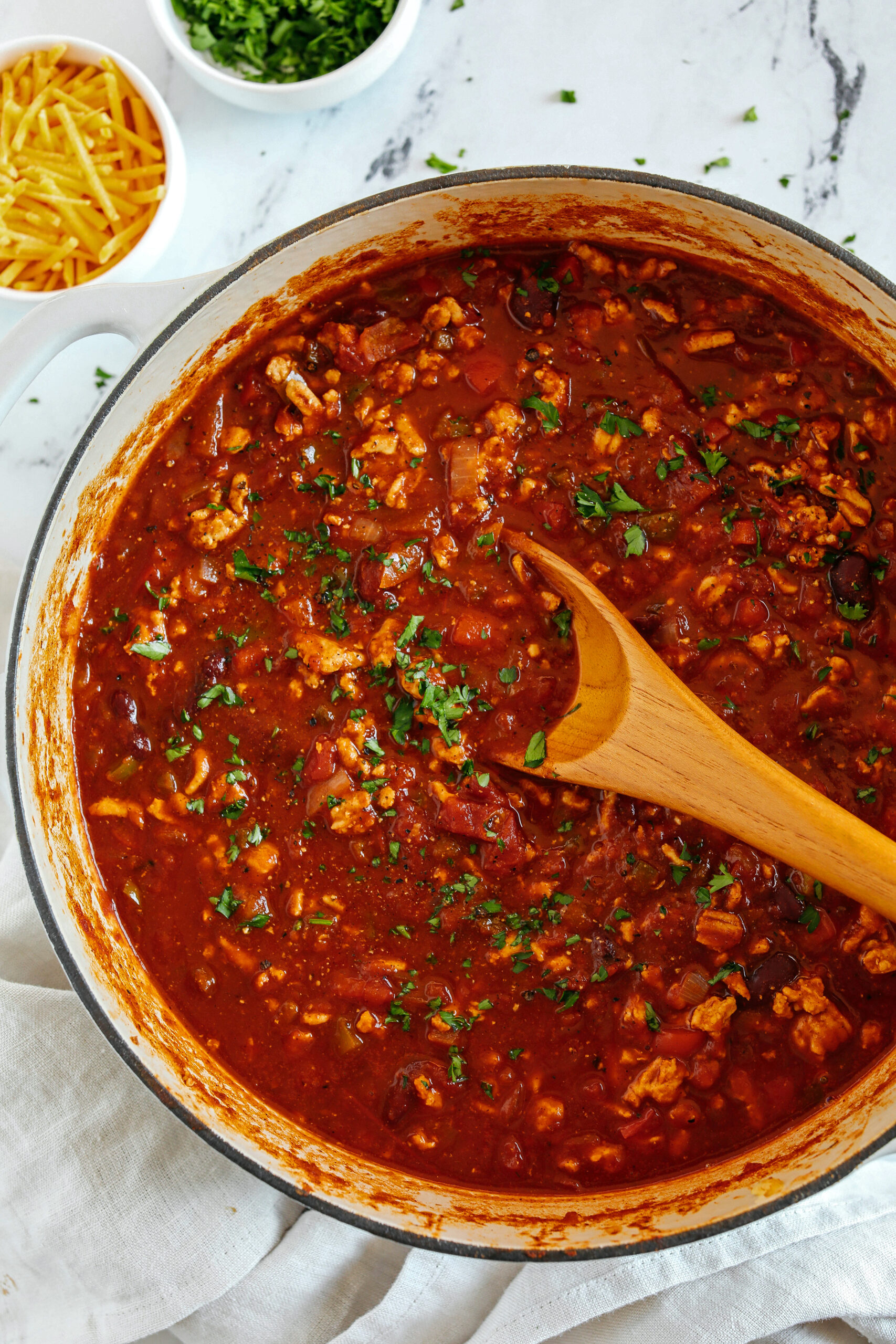 The BEST Healthy Turkey Chili recipe full of fresh veggies, lean ground turkey and loaded with flavor!  The perfect cozy chili you can easily make in our instant pot, crock pot or right on the stove!