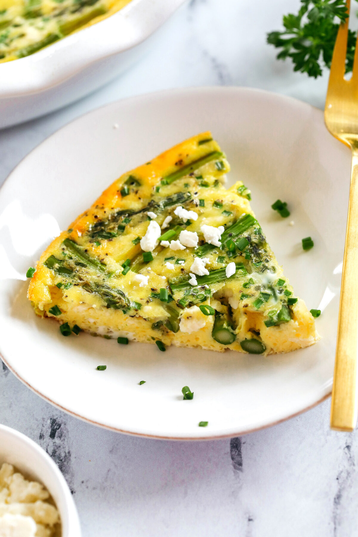This healthy Asparagus and Feta Crustless Quiche is easily made with just a few simple ingredients, tastes delicious and makes the perfect low-carb dish you can enjoy for any meal!