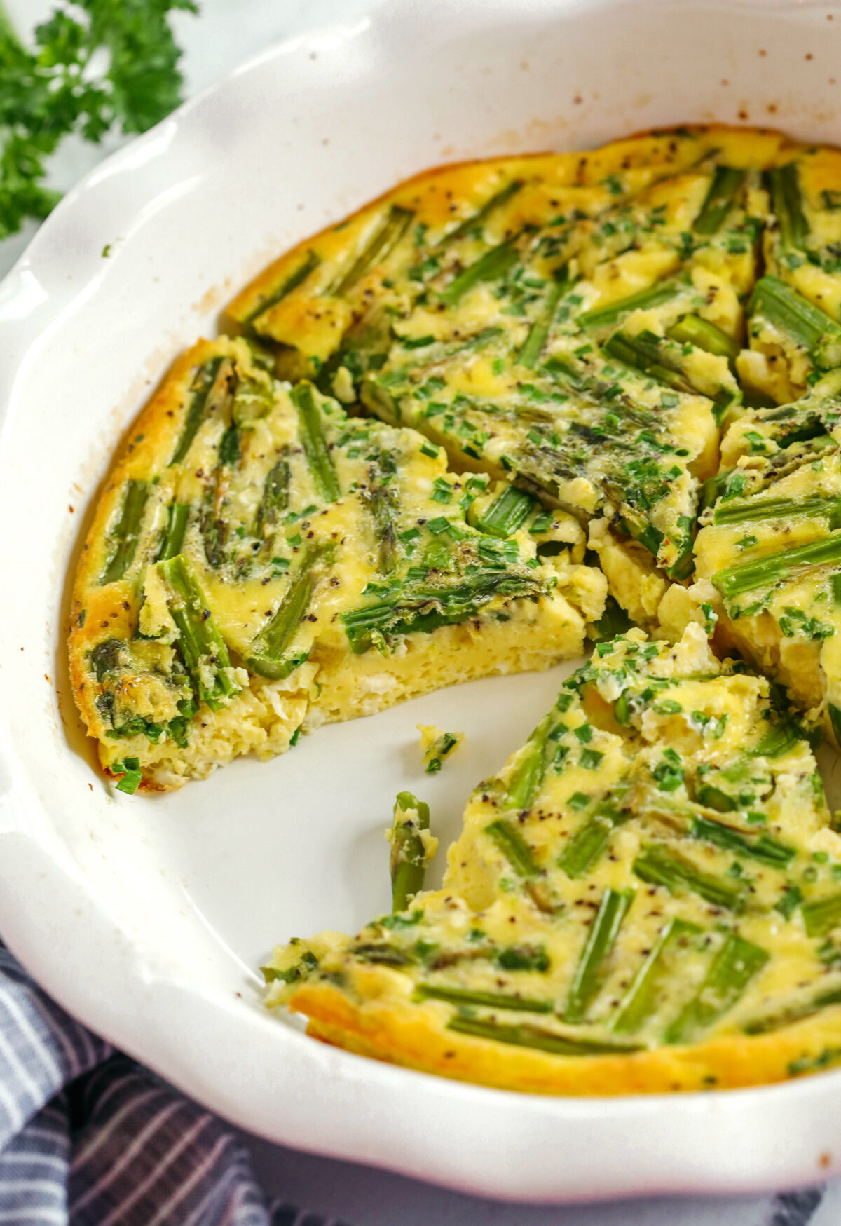 This healthy Asparagus and Feta Crustless Quiche is easily made with just a few simple ingredients, tastes delicious and makes the perfect low-carb dish you can enjoy for any meal!