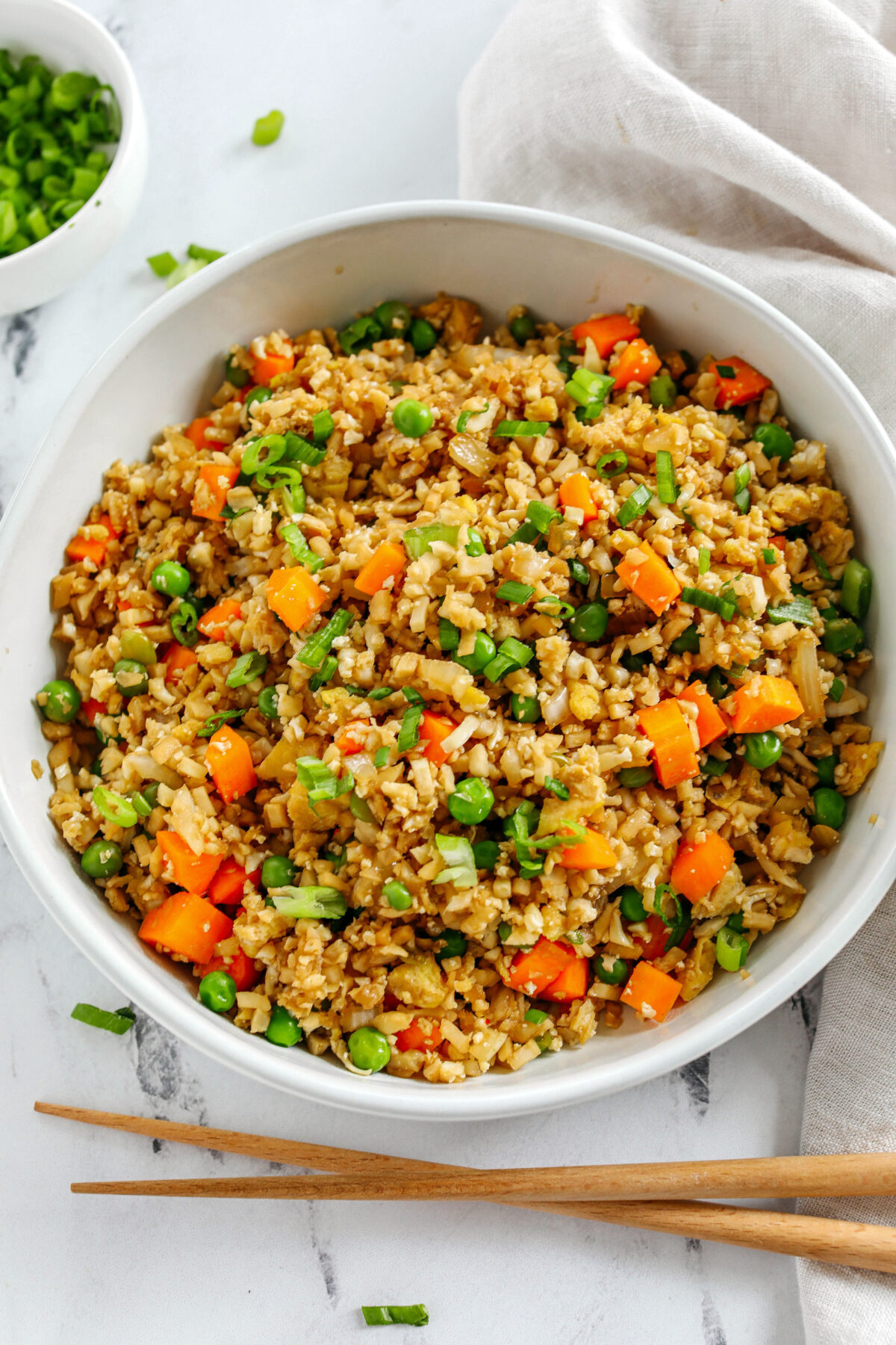 Skip the takeout and enjoy this Healthy Cauliflower Fried Rice in just 15 minutes!  Packed with veggies, low in carbs and can be served as a delicious side dish or a main dish with added protein!
