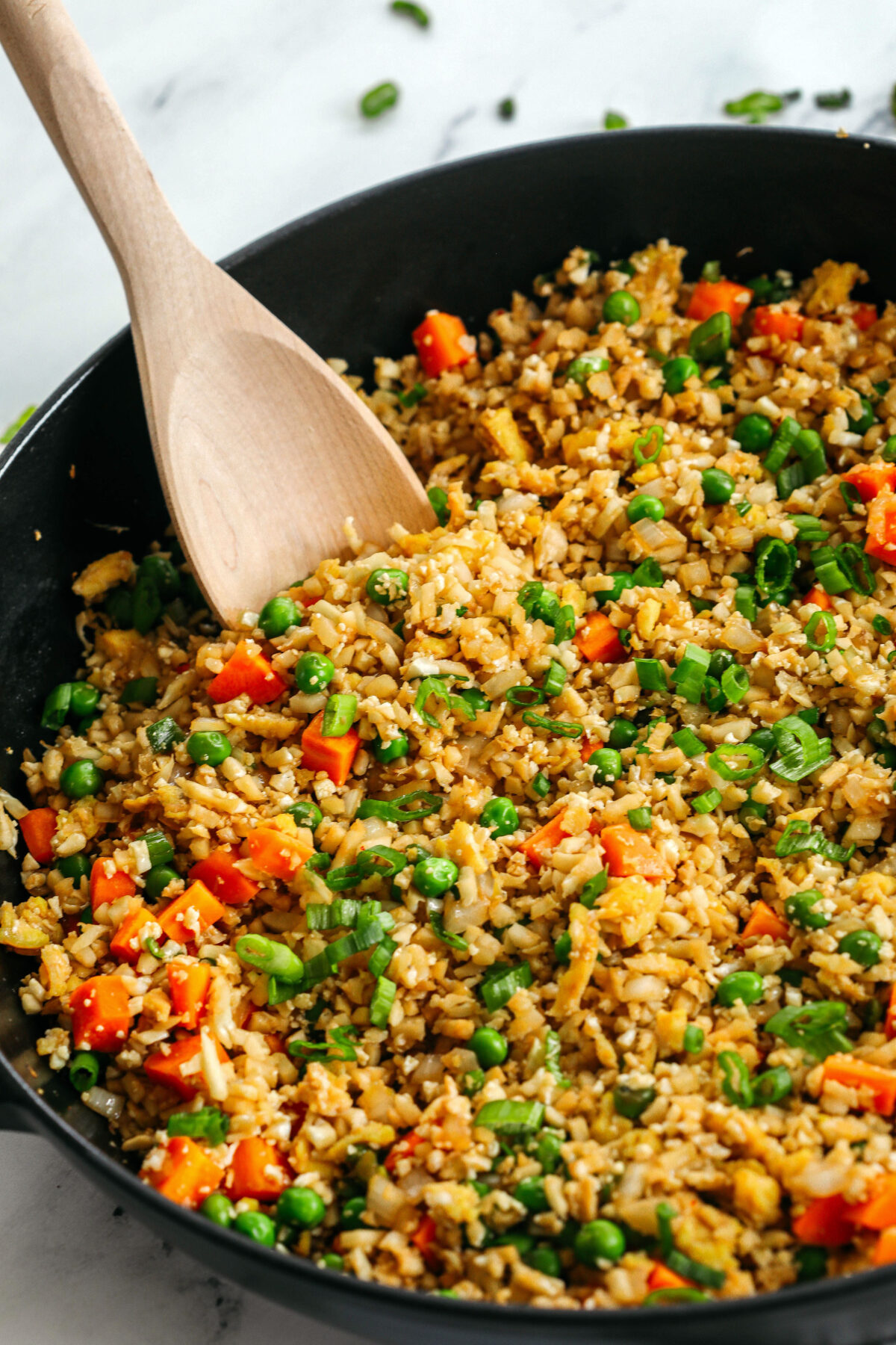Skip the takeout and enjoy this Healthy Cauliflower Fried Rice in just 15 minutes!  Packed with veggies, low in carbs and can be served as a delicious side dish or a main dish with added protein!