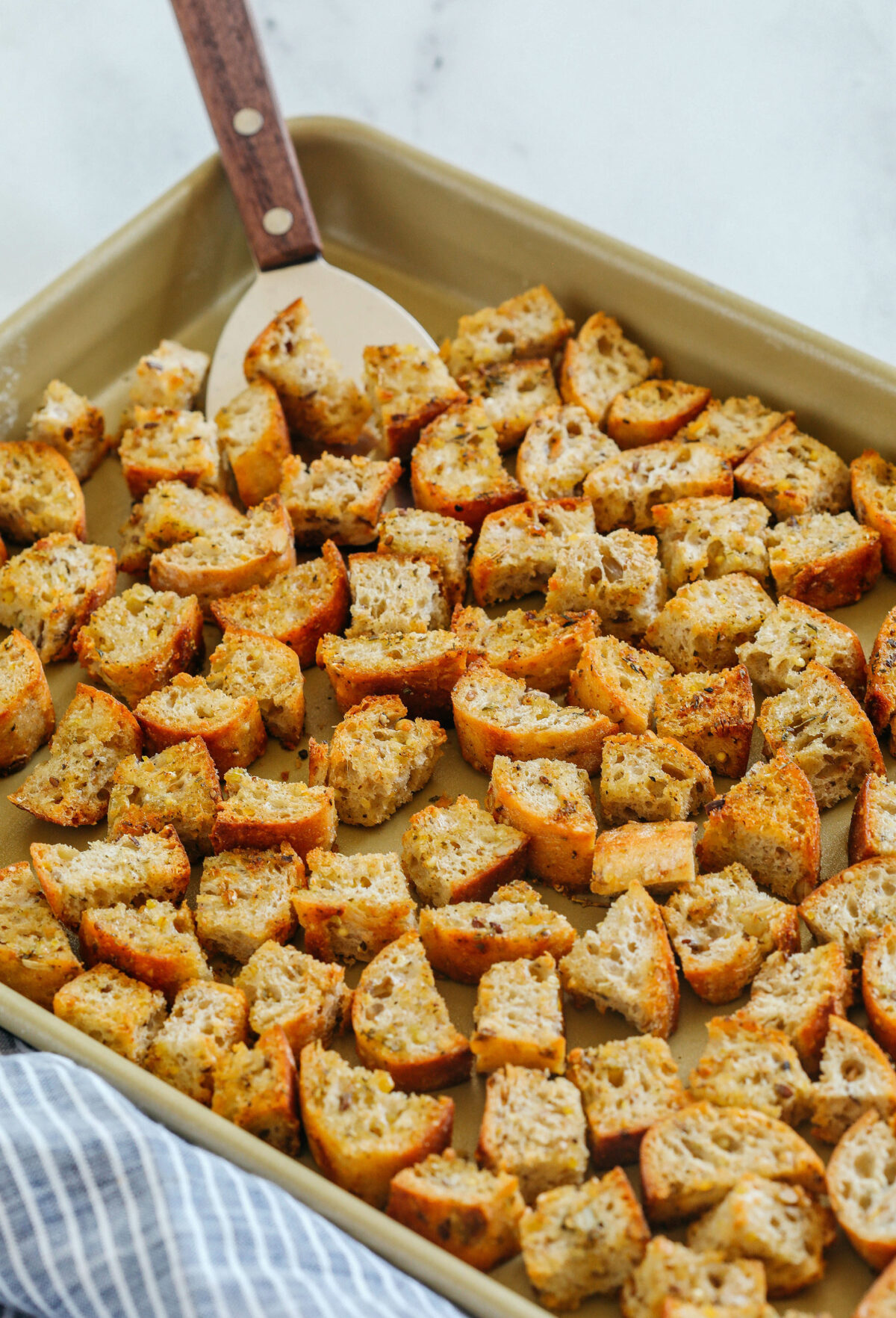Learn how to make Easy Homemade Croutons that are crispy, garlicky and super quick to make!  Use them as a topping for salads, soups, stuffing and more!