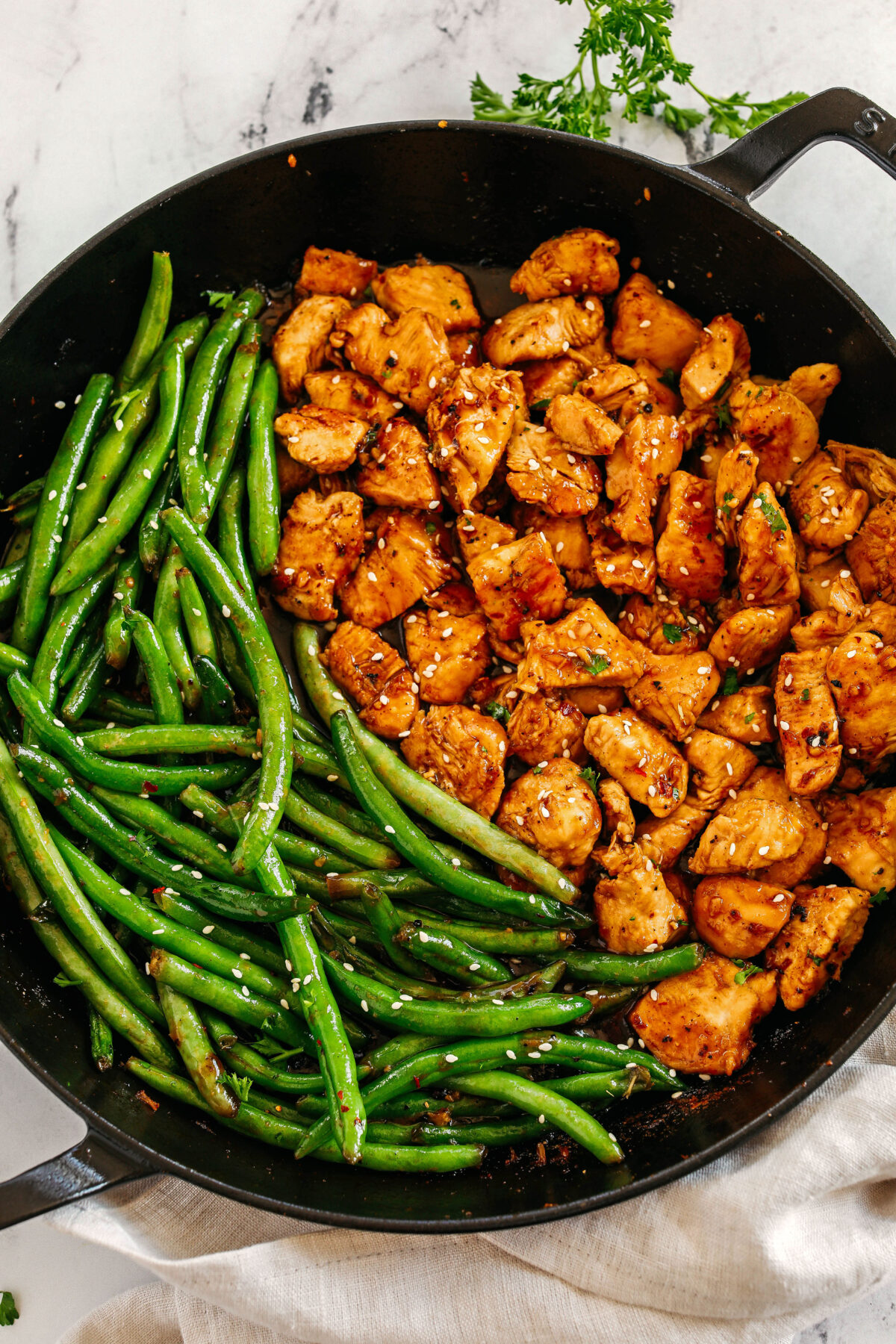 Super flavorful Honey Garlic Chicken and Green Beans make the perfect weeknight meal smothered in a delicious sauce that tastes way better than take-out!  Serve over rice and have dinner on your table in under 30 minutes! 