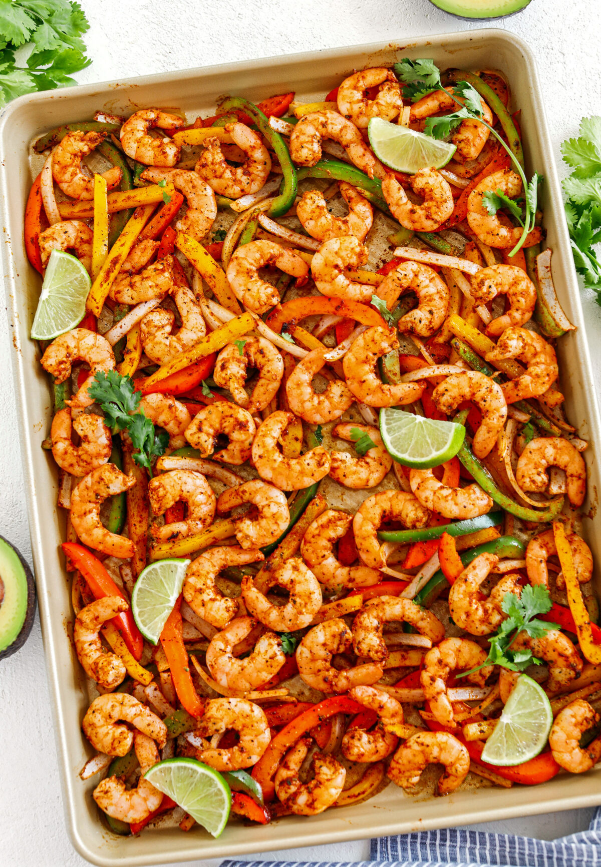 EASY Sheet Pan Shrimp Fajitas with all your favorite Mexican flavors that makes the perfect healthy weeknight dinner easily made all on one pan in under 20 minutes!  Perfect recipe for your Sunday meal prep too!  