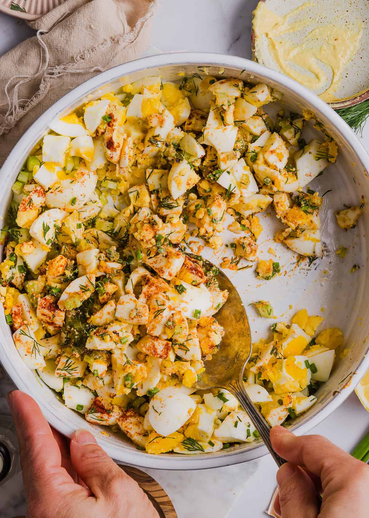 This Healthy Egg Salad recipe is packed with protein, fresh flavors and made healthier with Greek yogurt in place of mayo! Enjoy this on a sandwich, lettuce wrap, with crackers or straight from the bowl!