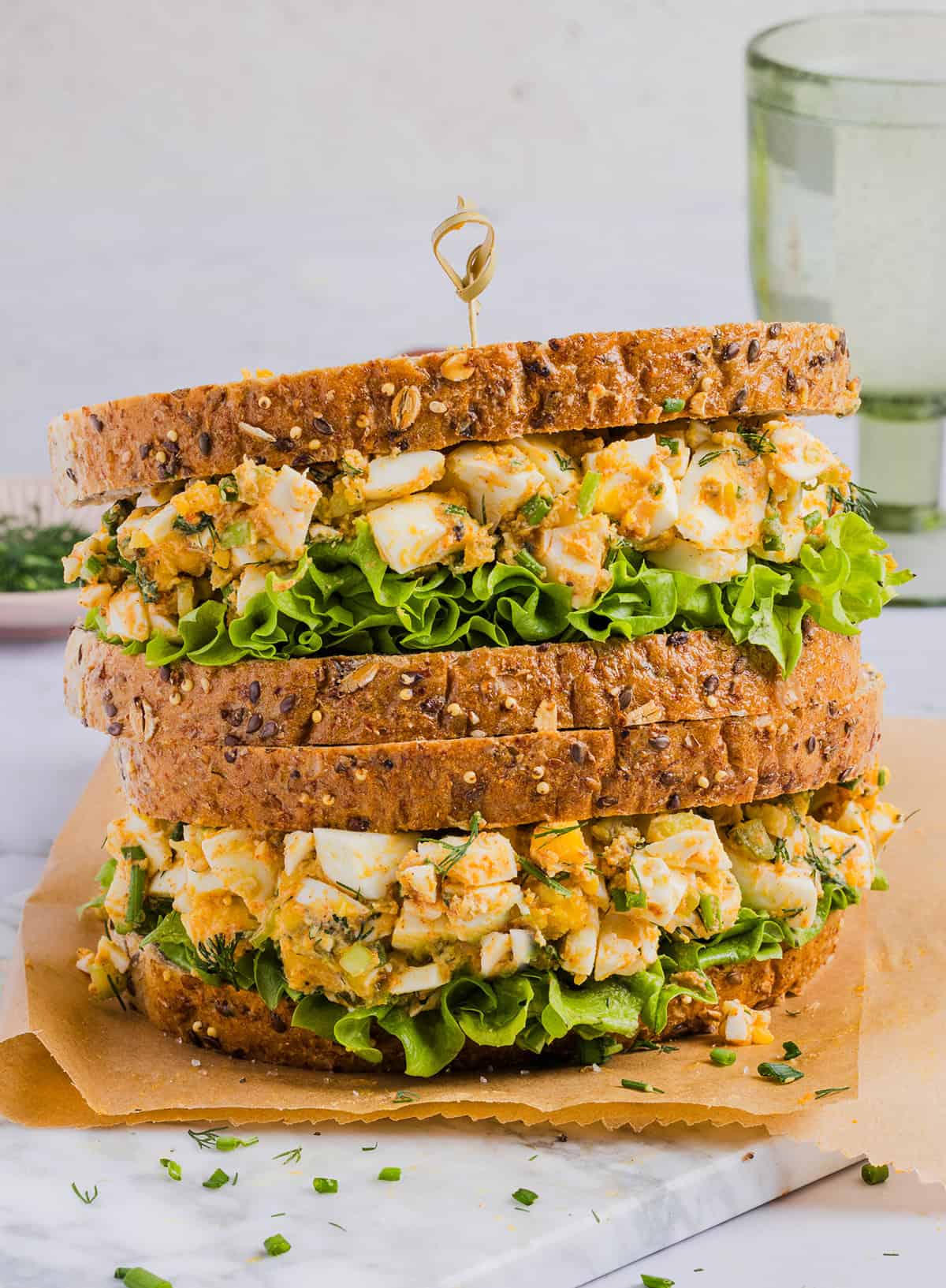 This Healthy Egg Salad recipe is packed with protein, fresh flavors and made healthier with Greek yogurt in place of mayo! Enjoy this on a sandwich, lettuce wrap, with crackers or straight from the bowl!