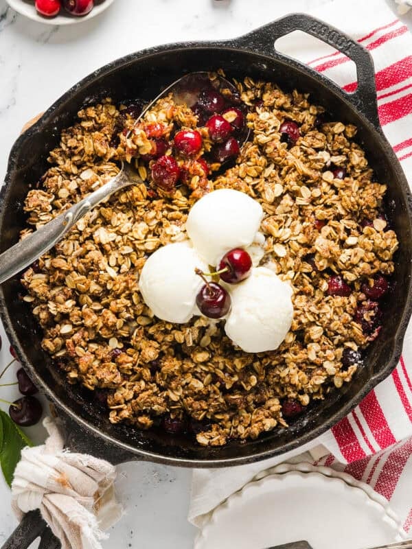 This Healthy Cherry Crisp recipe is the ultimate summer dessert! Bursting with sweet cherries and a wholesome oat topping, this warm cherry crisp easily comes together with just a few simple ingredients!