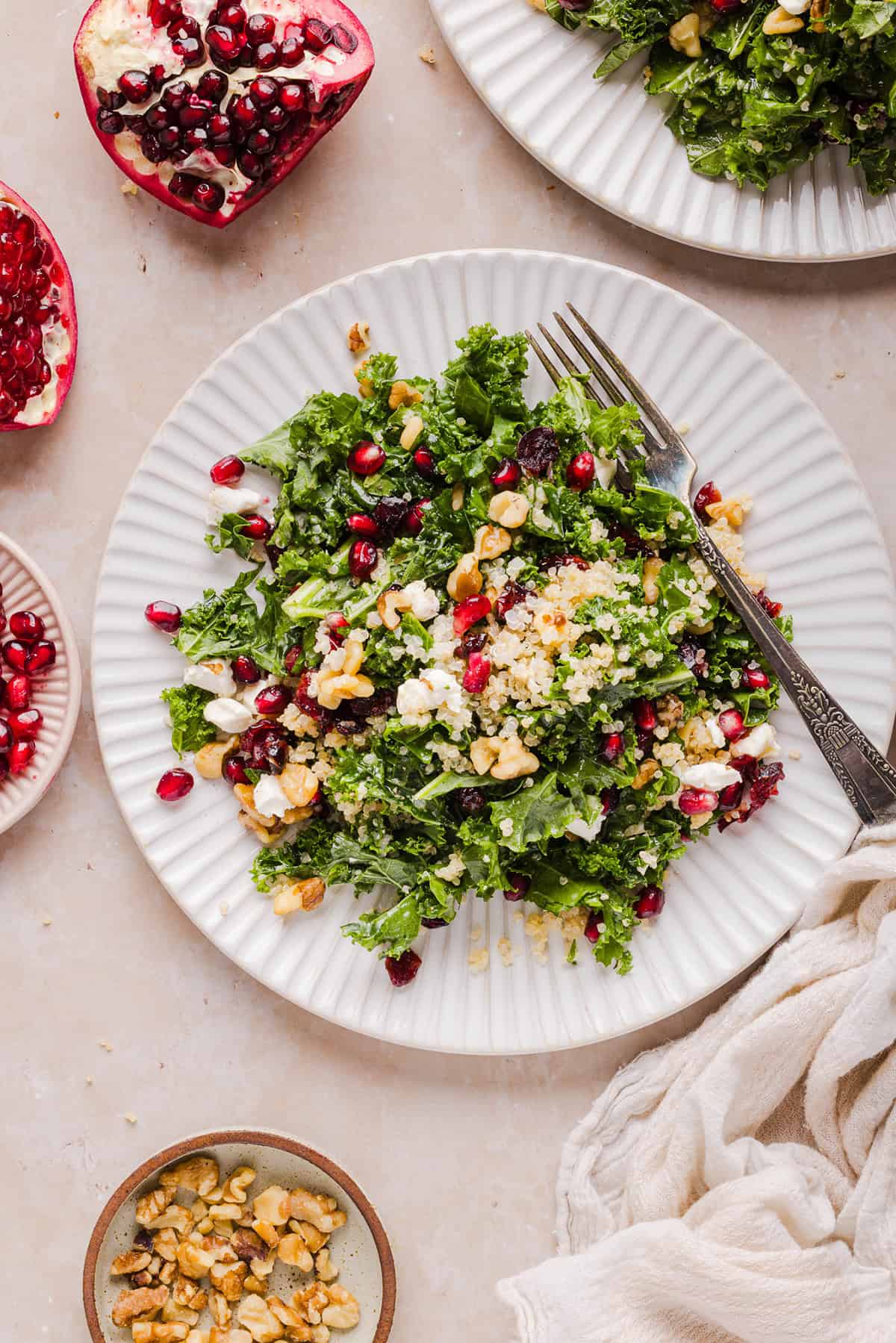 This Winter Kale and Quinoa Salad is packed with tender kale, fluffy quinoa, sweet pomegranate seeds, creamy goat cheese, crunchy walnuts, and a simple apple cider vinaigrette. The perfect healthy salad for the holidays, meal prep, or an easy winter lunch!