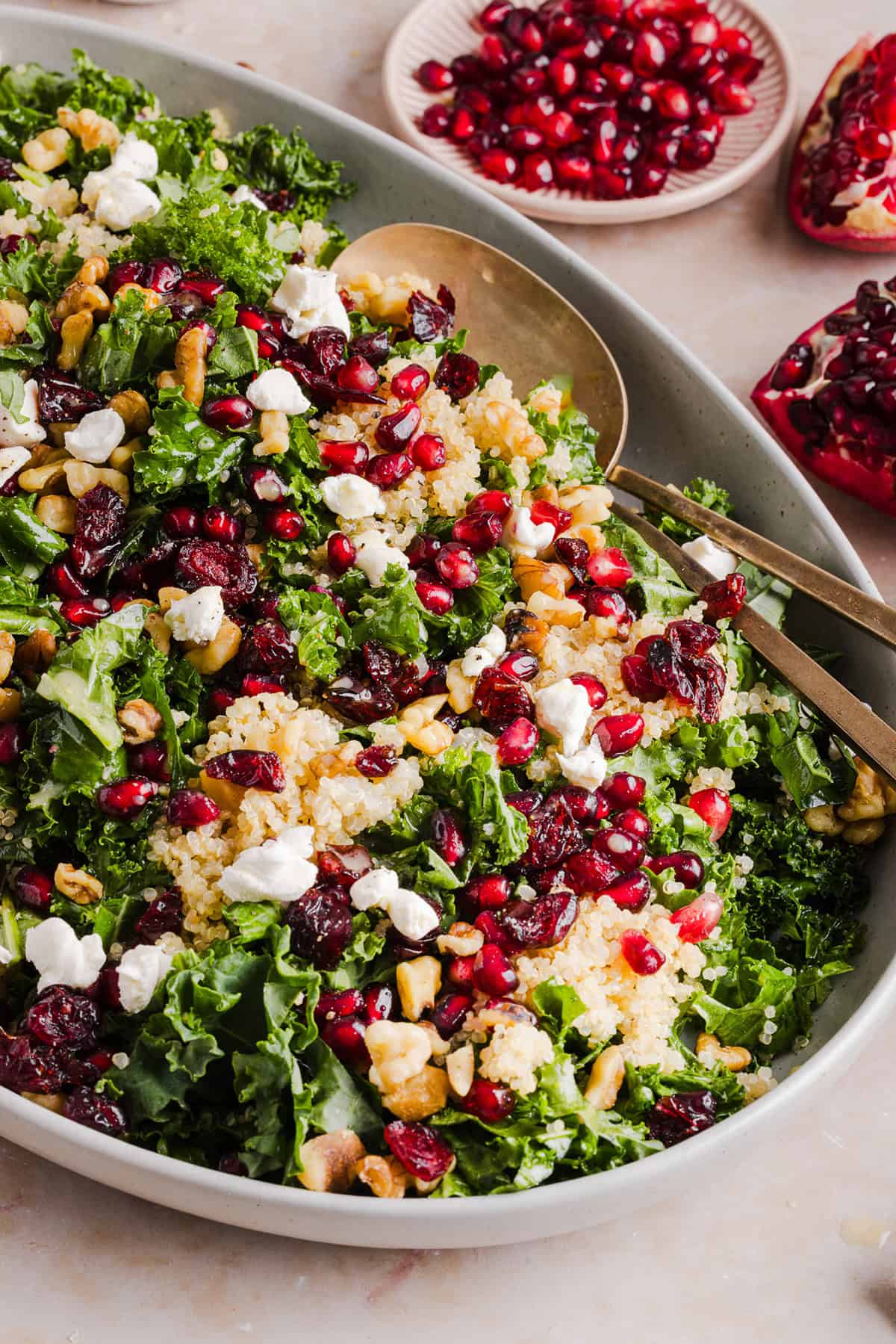 This Winter Kale and Quinoa Salad is packed with tender kale, fluffy quinoa, sweet pomegranate seeds, creamy goat cheese, crunchy walnuts, and a simple apple cider vinaigrette. The perfect healthy salad for the holidays, meal prep, or an easy winter lunch!