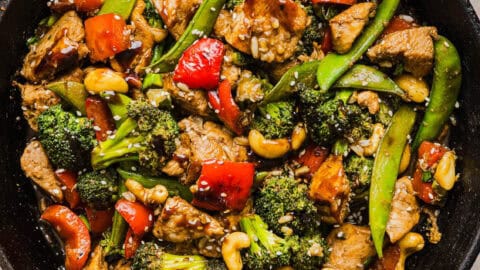 This Healthy Cashew Chicken Stir Fry is the perfect weeknight meal that is quick and easy to make, full of fresh veggies and tossed together in a delicious homemade peanut sauce!