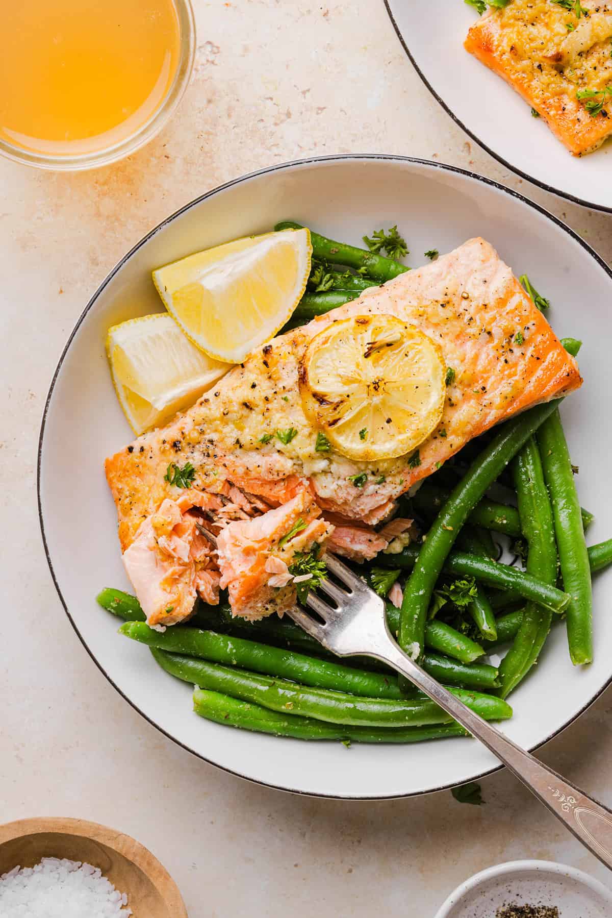The most flavorful Garlic Butter Baked Salmon that is tender, flaky and coated in a rich garlicky sauce with lemon and Dijon. This simple healthy recipe easily comes together in under 20 minutes!
