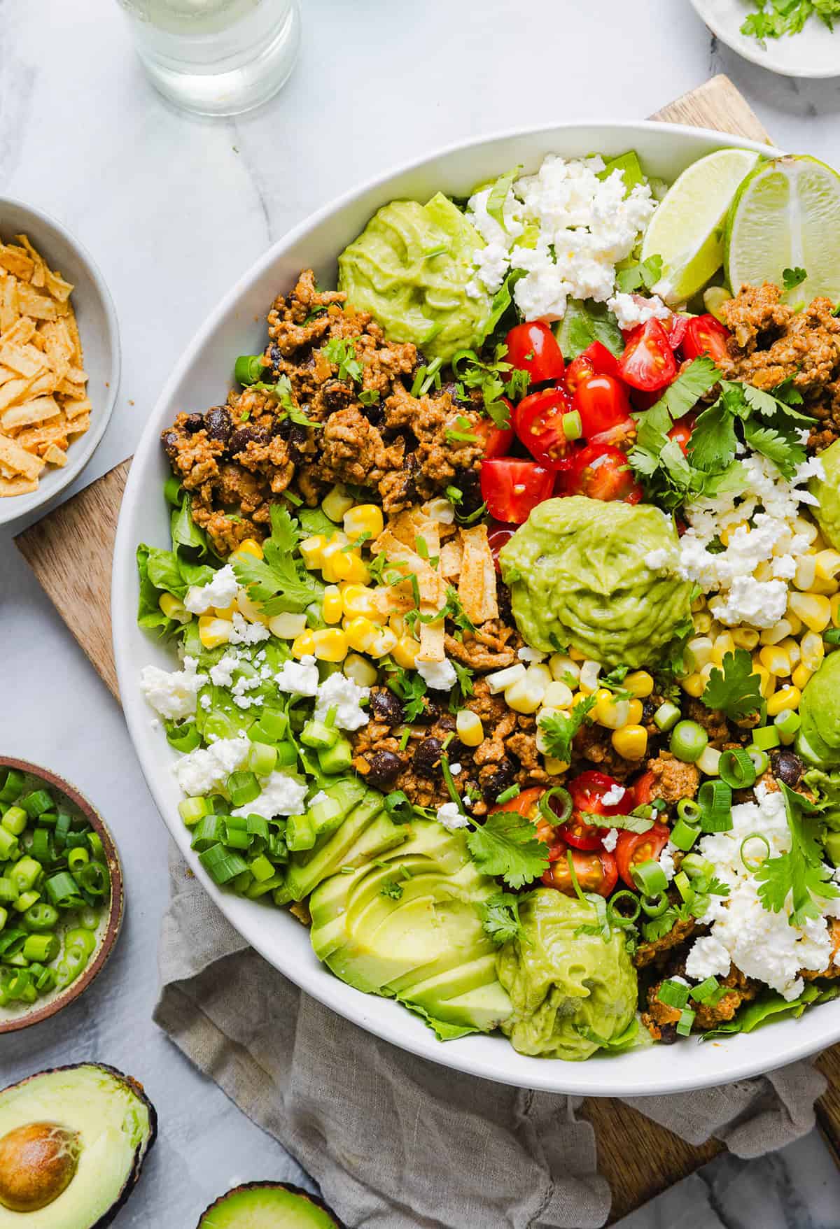 This quick and easy Healthy Taco Salad is made with seasoned ground turkey, fresh veggies and all your favorite toppings to pack in the flavor! Perfect for busy weeknights, meal prep or even serving a crowd!