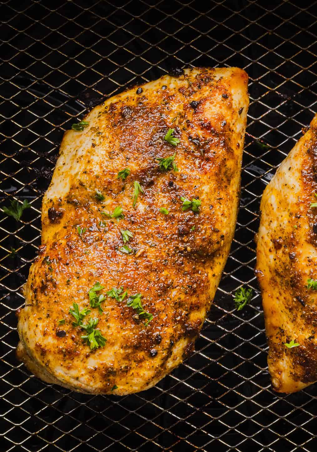 Juicy Air Fryer Chicken Breast recipe that comes out perfectly every time in just 20 minutes! Seasoned with a blend of herbs and spices for a delicious, healthy meal great for busy weeknights or when you need to meal prep.