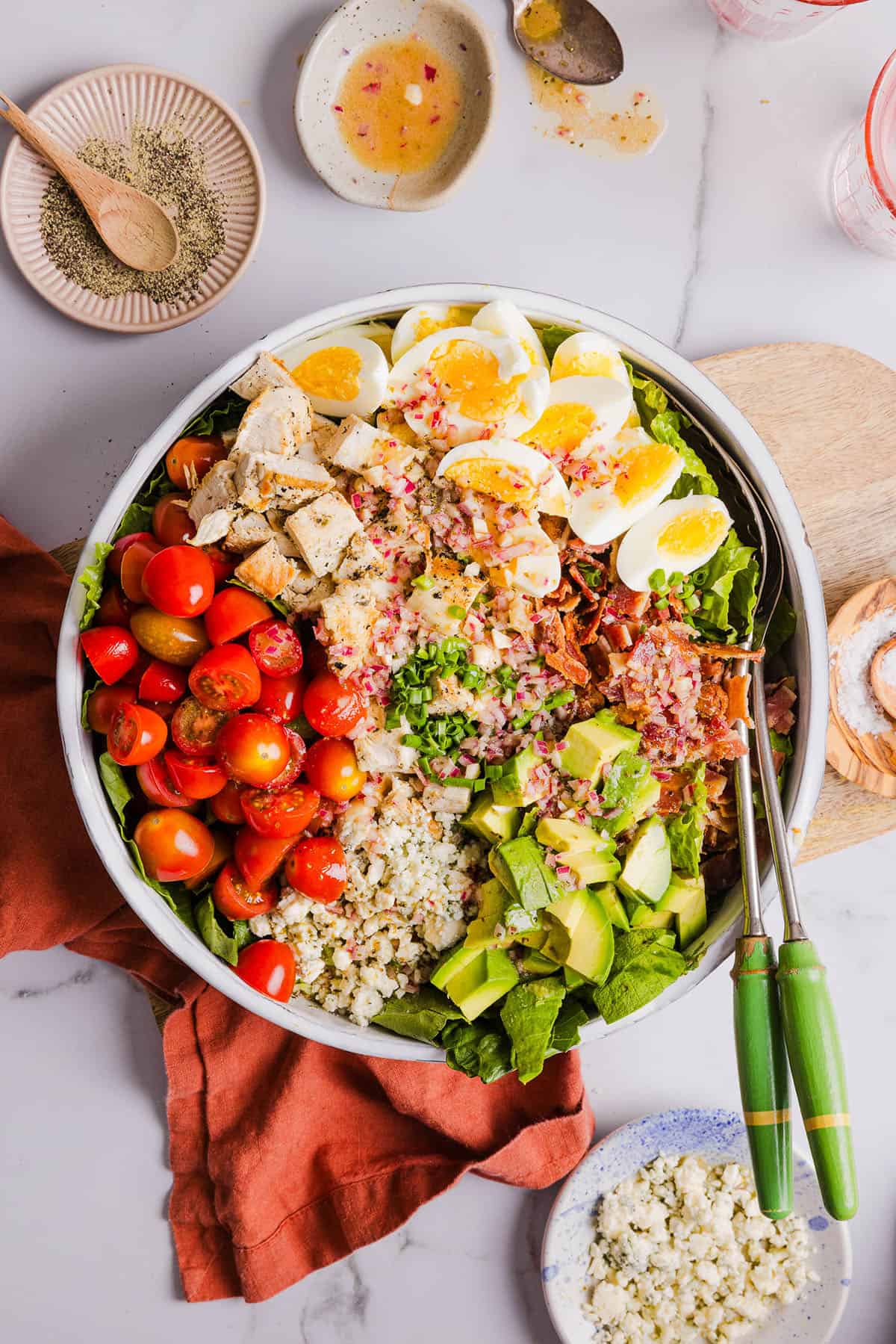 Protein-packed Chicken Cobb Salad loaded with tender chicken, crispy bacon, creamy avocado and tangy blue cheese all tossed in a delicious red wine vinaigrette! A fresh, hearty and satisfying salad that is perfect for lunch or a light dinner.