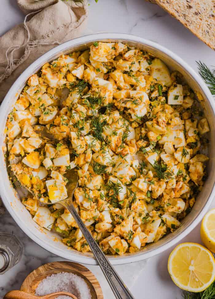 This Healthy Egg Salad recipe is packed with protein, fresh flavors and made healthier with Greek yogurt in place of mayo! Enjoy this on a sandwich, lettuce wrap, with crackers or straight from the bowl!