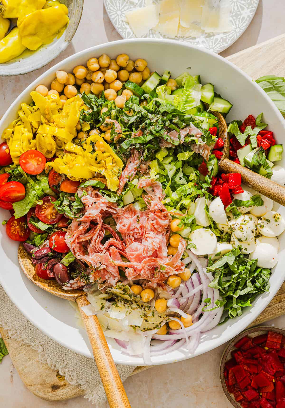 This Italian Chopped Salad recipe tastes just like your favorite grinder, but lighter and SO good! Loaded with crisp lettuce, savory salami, chickpeas, fresh veggies and the best homemade dressing, all finely chopped so you get the perfect bite every time!