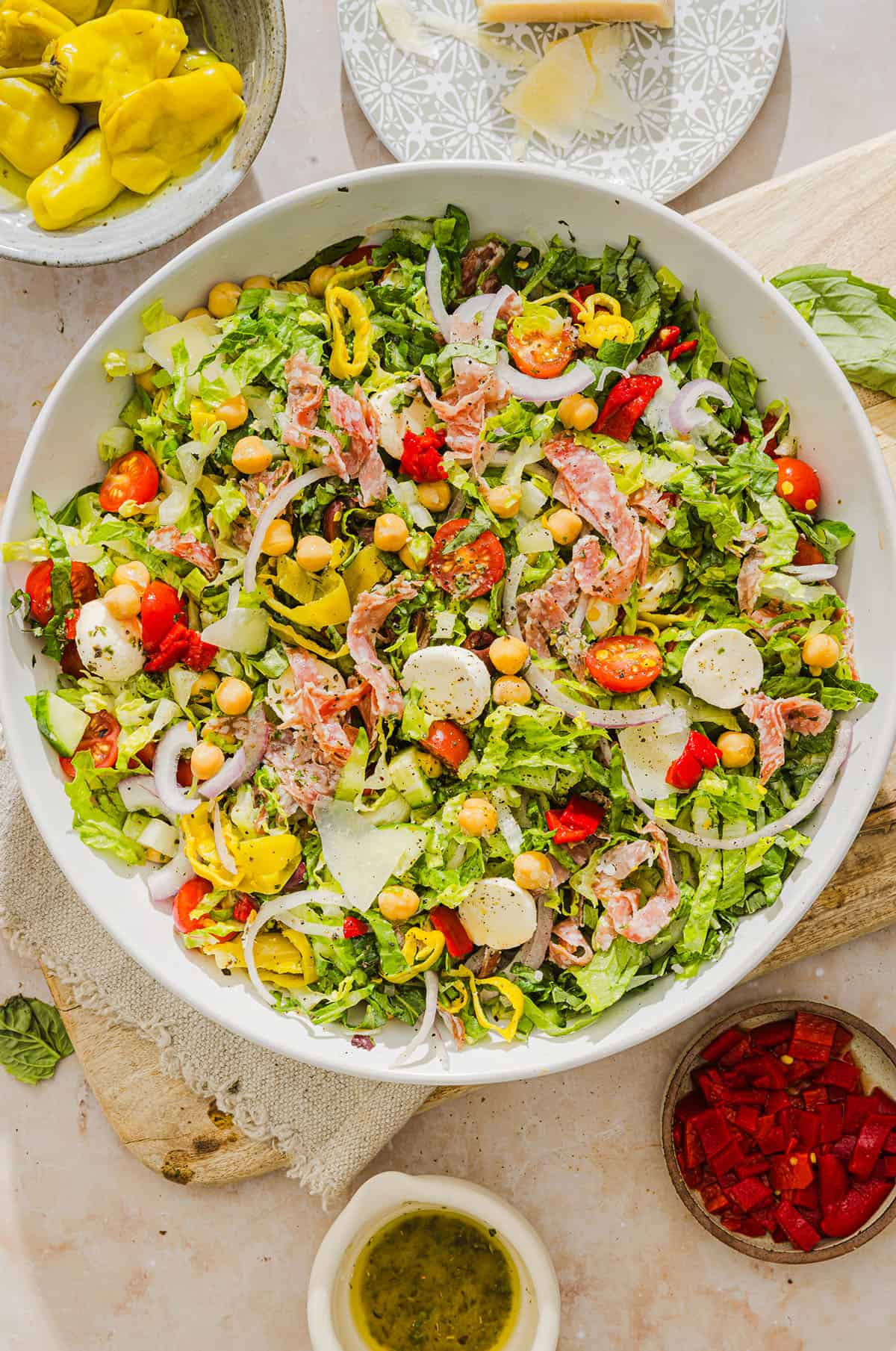 This Italian Chopped Salad recipe tastes just like your favorite grinder, but lighter and SO good! Loaded with crisp lettuce, savory salami, chickpeas, fresh veggies and the best homemade dressing, all finely chopped so you get the perfect bite every time!
