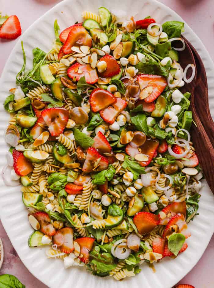 This Strawberry Balsamic Pasta Salad is fresh, flavorful, and perfect for spring and summer! Made with juicy strawberries, tender pasta, fresh basil, creamy mozzarella and crisp cucumbers all tossed in a lightly sweet balsamic dressing.