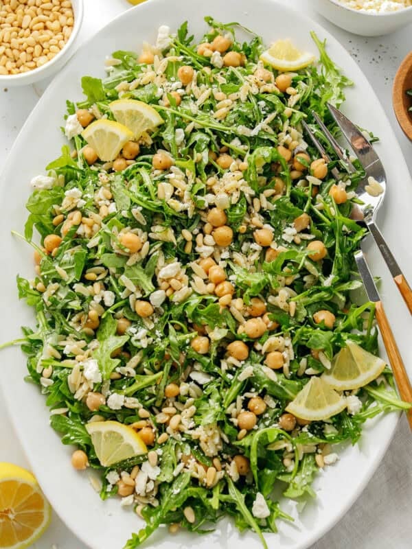 This Lemon Arugula Orzo Salad is a bright, zesty pasta salad packed with fresh greens, tender orzo, protein-packed chickpeas, crumbled feta cheese and a simple lemon dressing. Perfect for spring and summer meals!