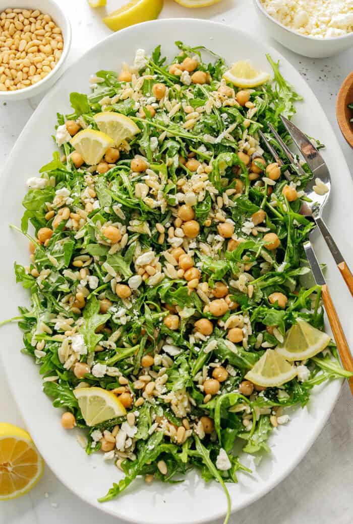 This Lemon Arugula Orzo Salad is a bright, zesty pasta salad packed with fresh greens, tender orzo, protein-packed chickpeas, crumbled feta cheese and a simple lemon dressing. Perfect for spring and summer meals!